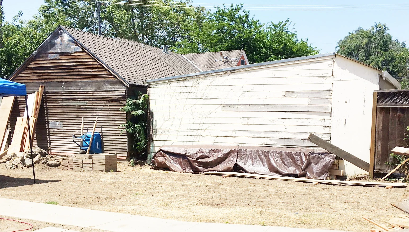 Remember this lovely wall? These ramshackle shacks are the back sides of our 2 neighbors garages. I'm sure you'll agree they were a bit of an eye sore. 
