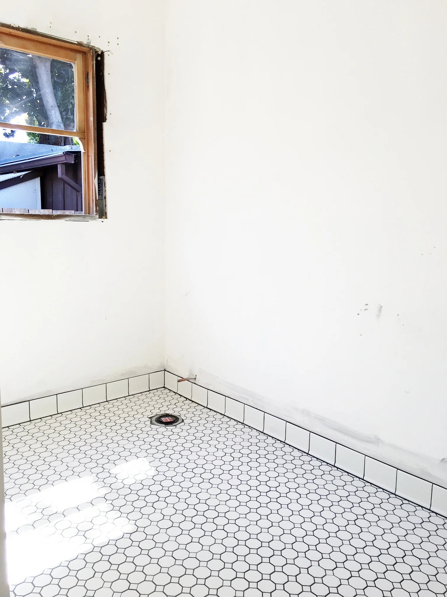 The floor tile is in. We chose a white hexagonal pattern with very dark gray grout. Lookin' good! Next: Installing the vanity and my fun job of restoring the claw foot tub. Ugh.