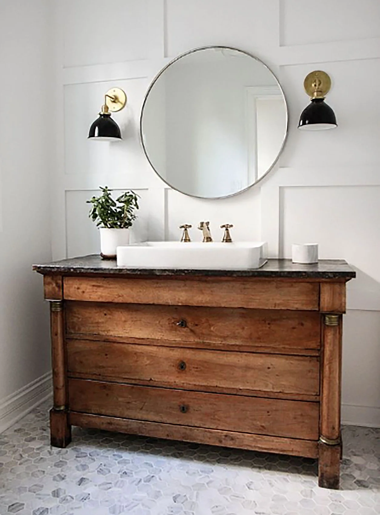 Here's my cottage bathroom inspiration. We found an old dresser that we converted to a vanity. We've put black granite countertops on it.