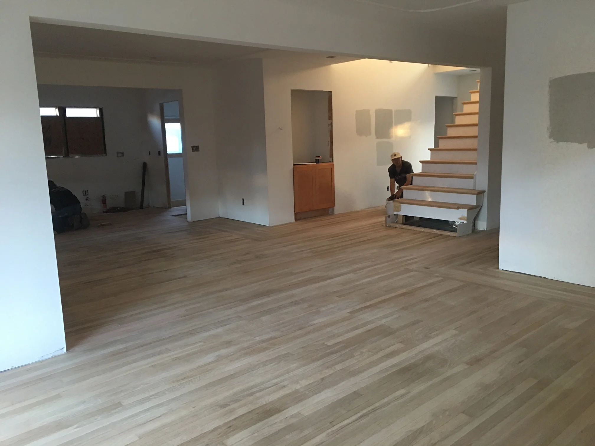 Here's a shot of the newly sanded floors. Remember that what you are looking at used to be 4 rooms so there was a lot of patch and repair that had to happen with these floors. These guys are such masters at what they do!