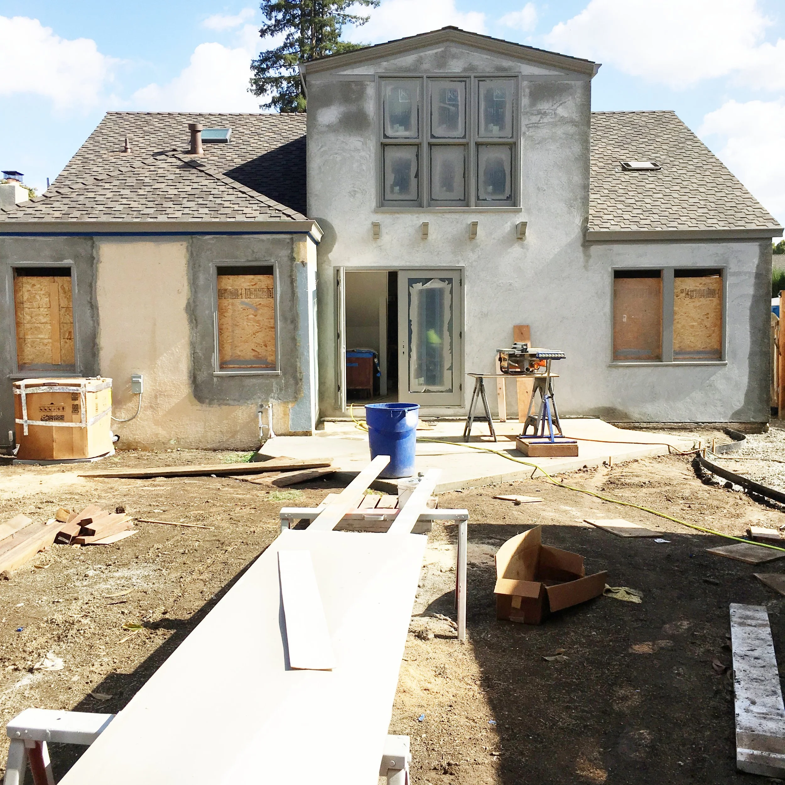 It still looks like a bit of a meth shack but it's coming along. You can see that the exterior trim has all been painted Chelsea Gray (love that color). The base of the back patio has been poured and final stucco will go on later this week. We are mixing the house paint color into the stucco so we don't have to paint. Fingers crossed.