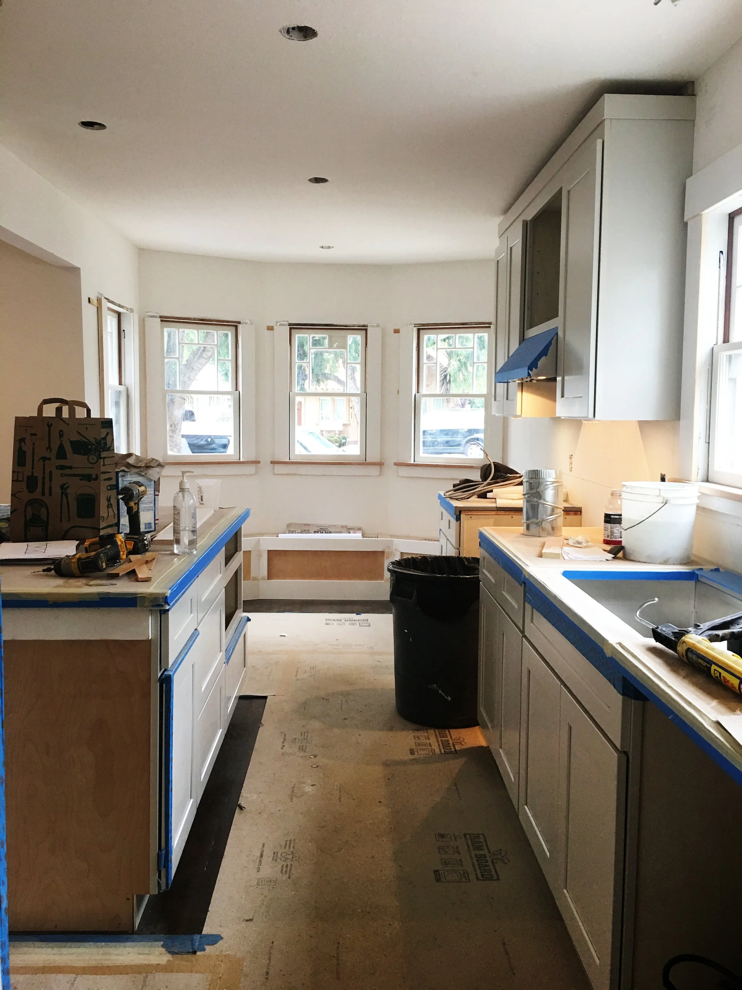 You can't imagine the light that poured into this room when all the plywood finally came down. It's a little bit of a tease because under this cardboard is honed marble, gray granite and beautiful refinished, stained hardwood floors (Douglas Fir in here).