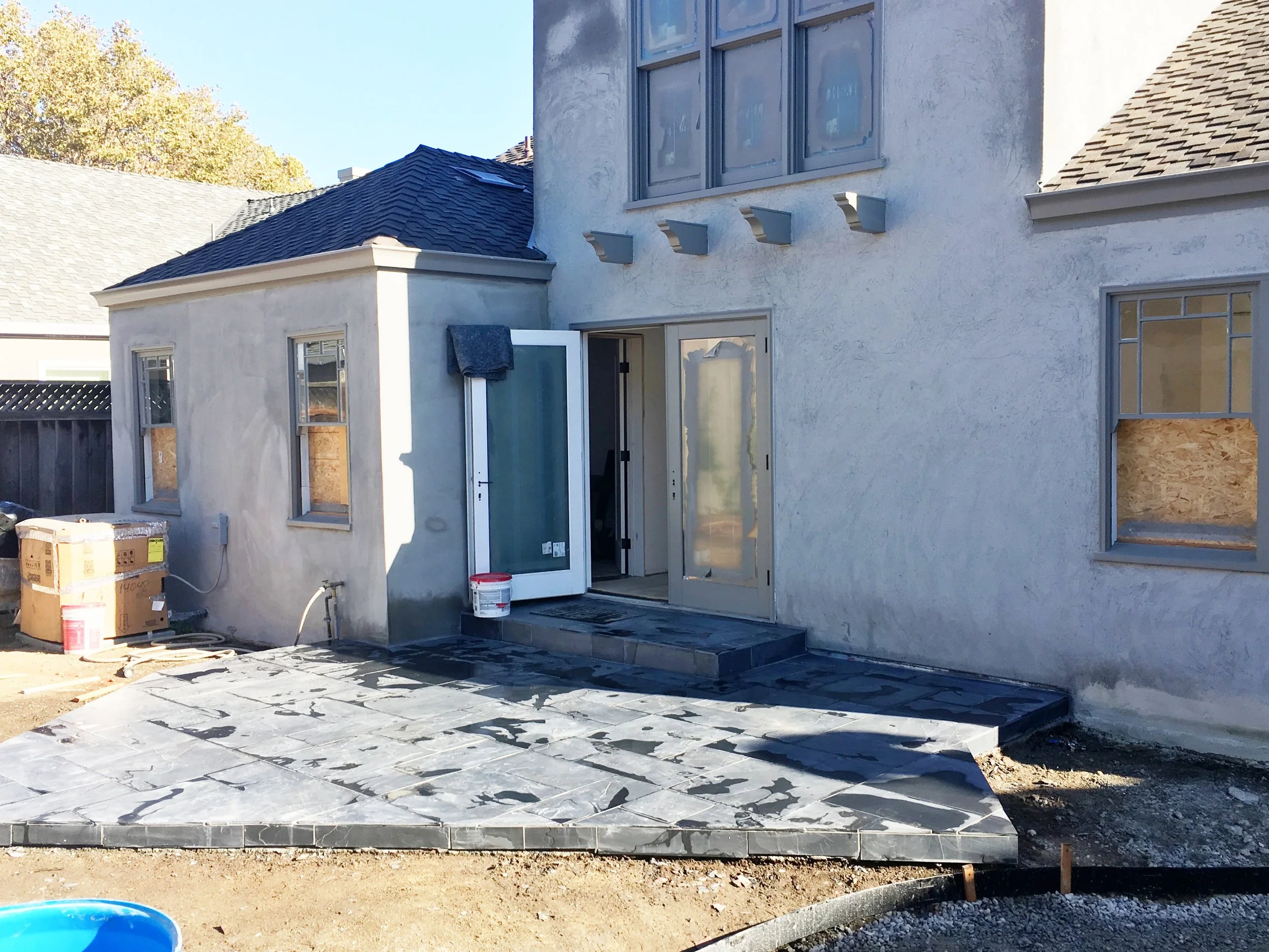 Completely by accident, we landed on this (super reasonable) charcoal gray slate for the patios in a Versailles pattern. Its dirty but you get the gist.