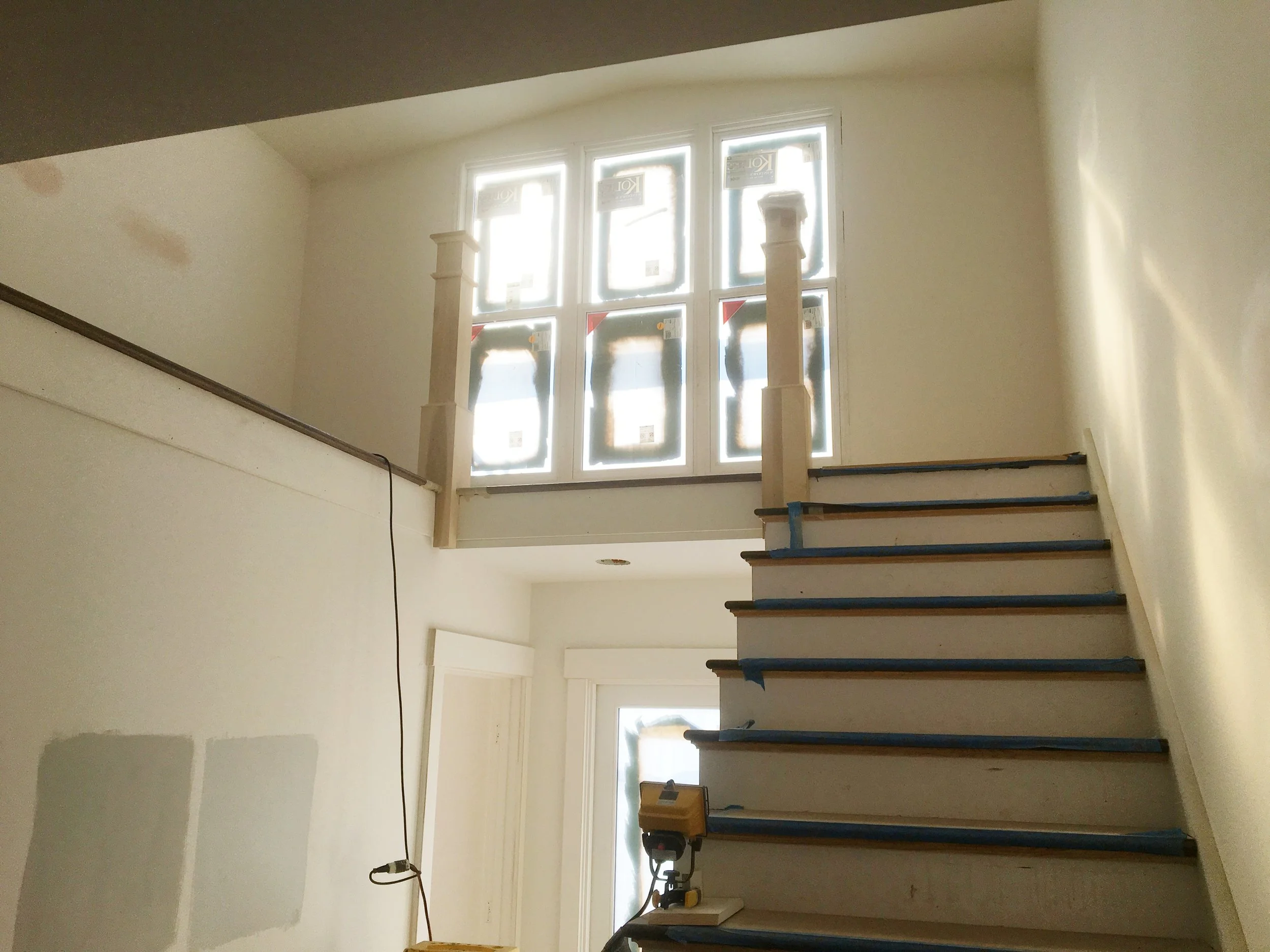 Look at the top of the stairs and you'll see the Top Newels. Lance just customized these to fit into the stair and hardwood floor. From here the ballusters and railing will be installed.