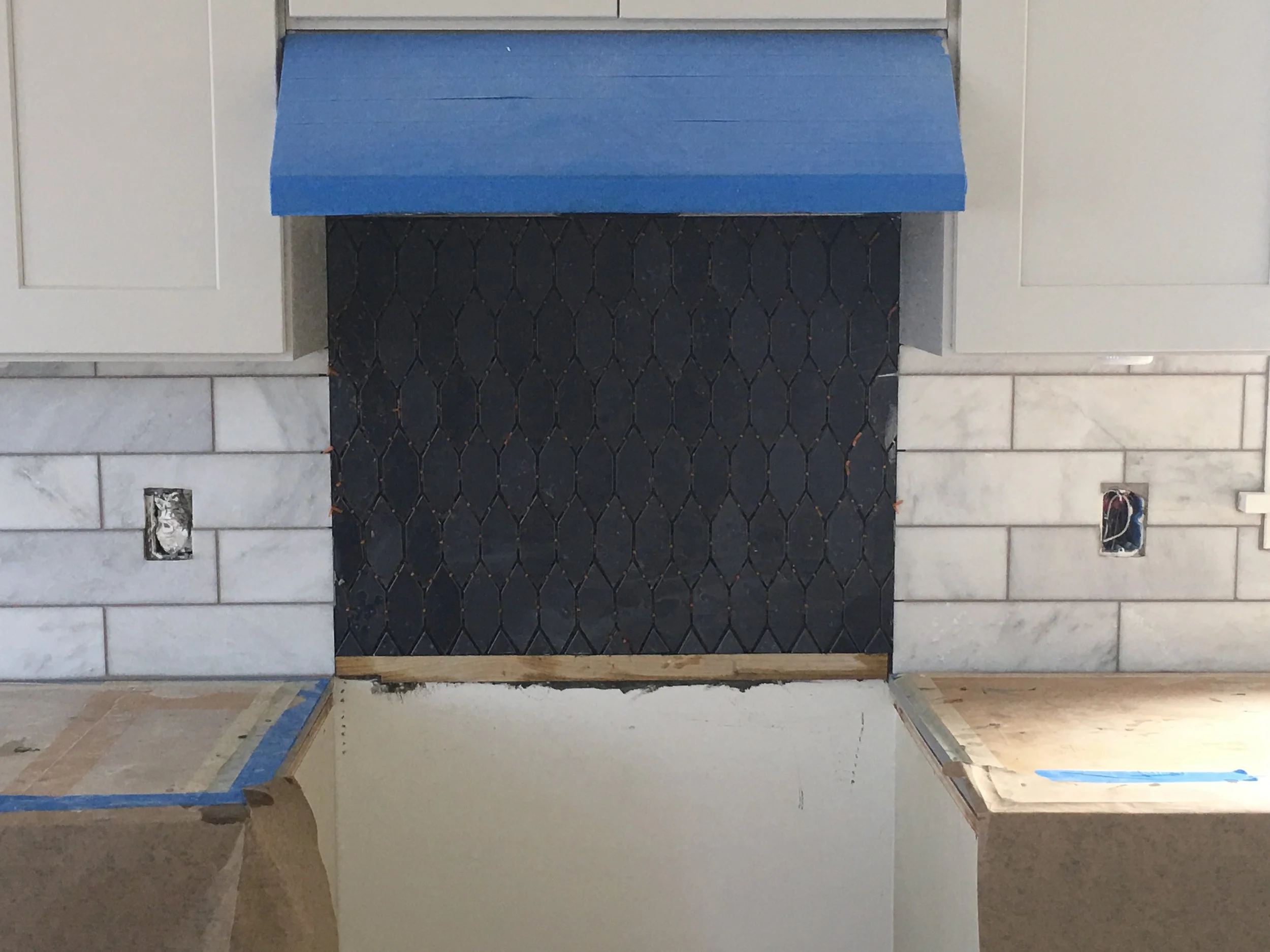 Above you'll see the two tiles laid out and ready to be installed. And, here is the backsplash laid in. The marble tile has been grouted with Oyster Gray grout. We'll grout the Heath tile tomorrow with the same grout. It just needs to set overnight.