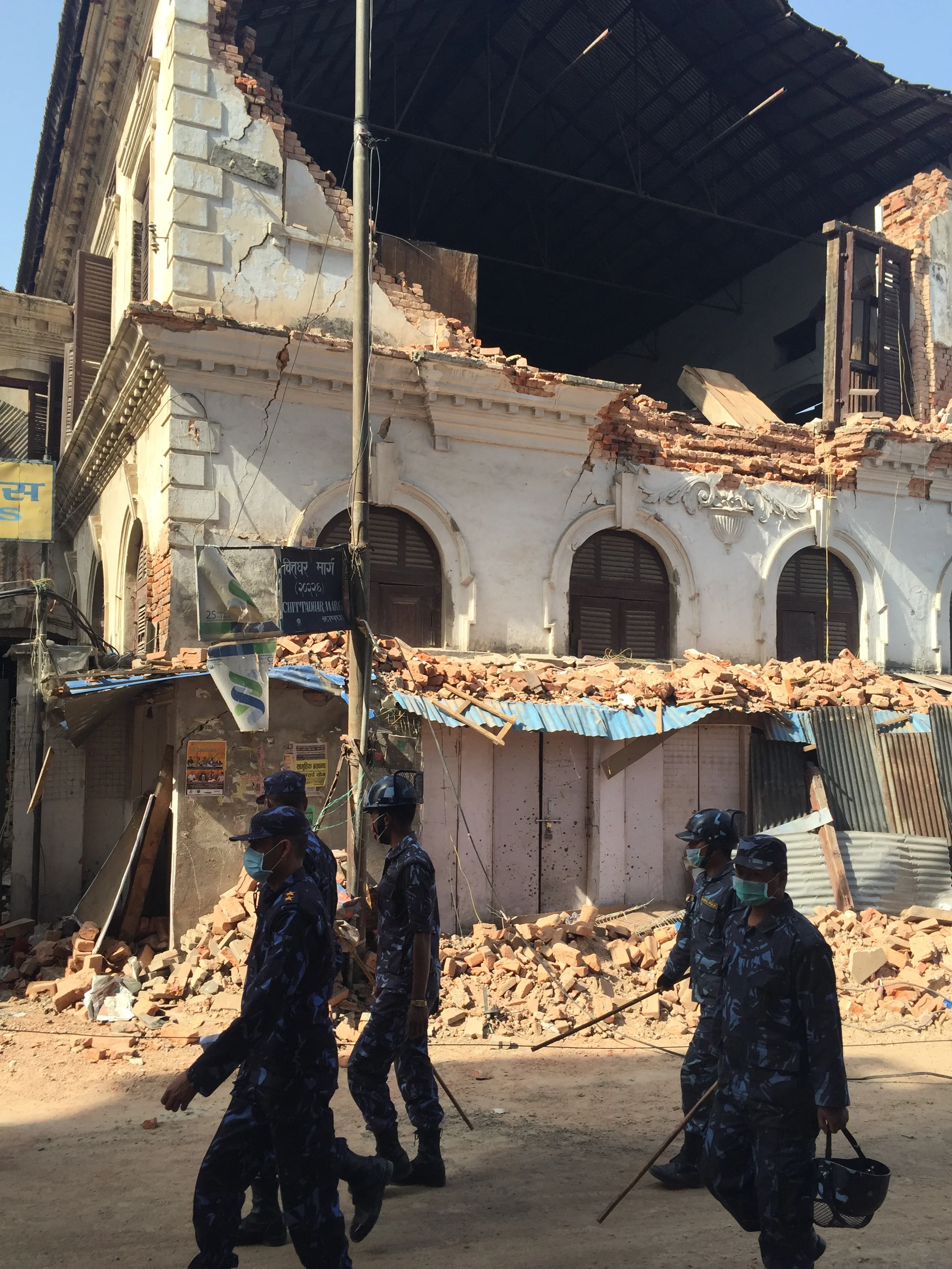 The beautiful colonial building in this photo was the 1st private school in Nepal. Soldiers pass by on their way to do more relief work.