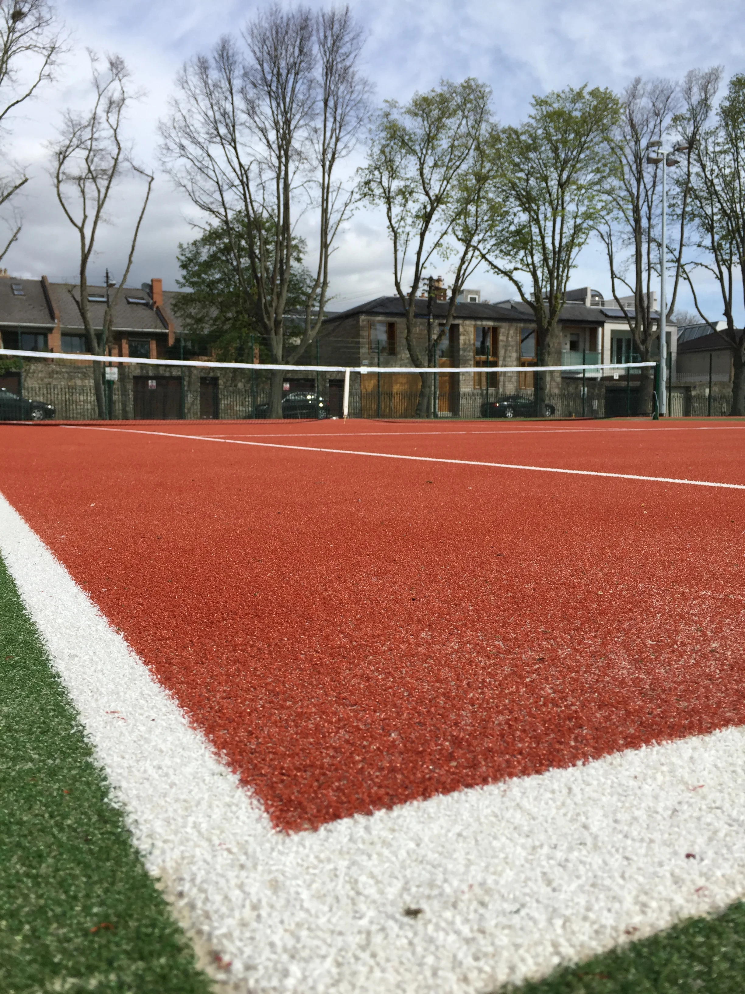 Sand filled turf provides an all weather playing surface for tennis