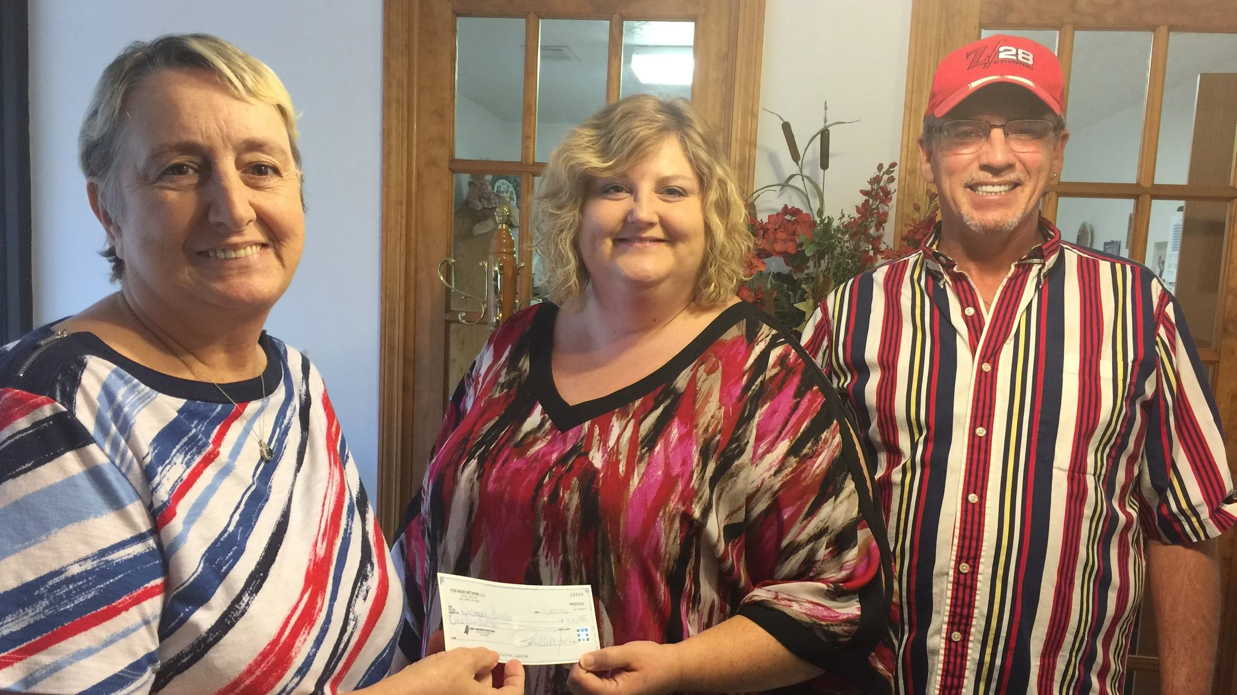 Account Executive Carrie Schimweg (middle) presents $100 check to Donna Buhler (Left), the winner of our Christmas Cash Extravaganza for the week of November 18, 2016.