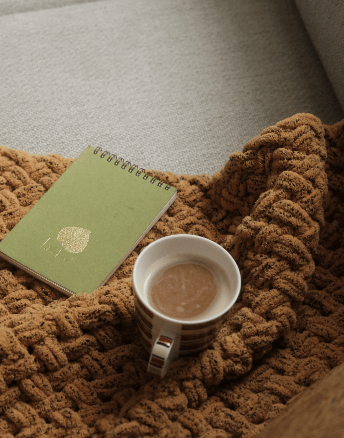 A cup of coffee and a journal for a woman in therapy with Sarah Sanders, LMFT
