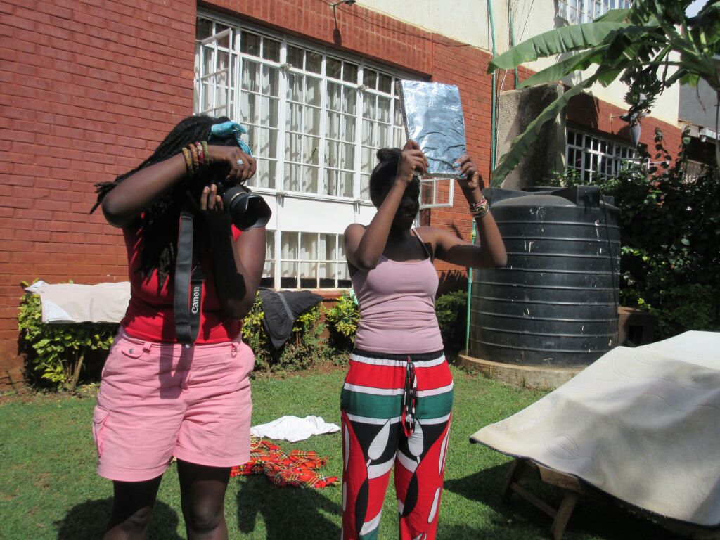 Awuor on camera and Deb working the make-shift reflector :P