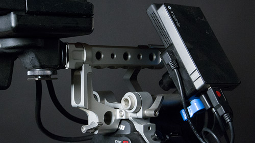 Transmitter attaches to C300's top handle, and also uses USB battery (2.5 hrs). You can optionally power the transmitter from a larger gold-mount (Anton Bauer) battery attached to back of camera .