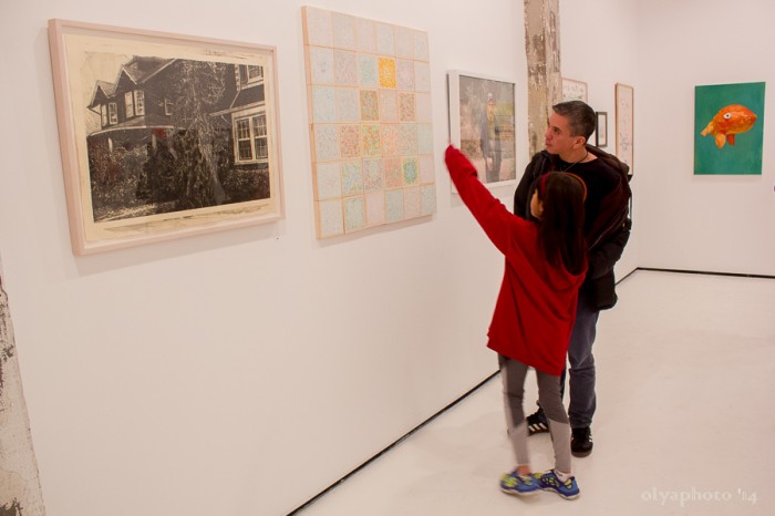 (visible first three) left to right: “Untitled” by Melissa Ling, “How to Cope” by Hannah Lee, “Hugh” by Maureen Drennan. Pictured: artists Simone Isip and Jordin Isip.