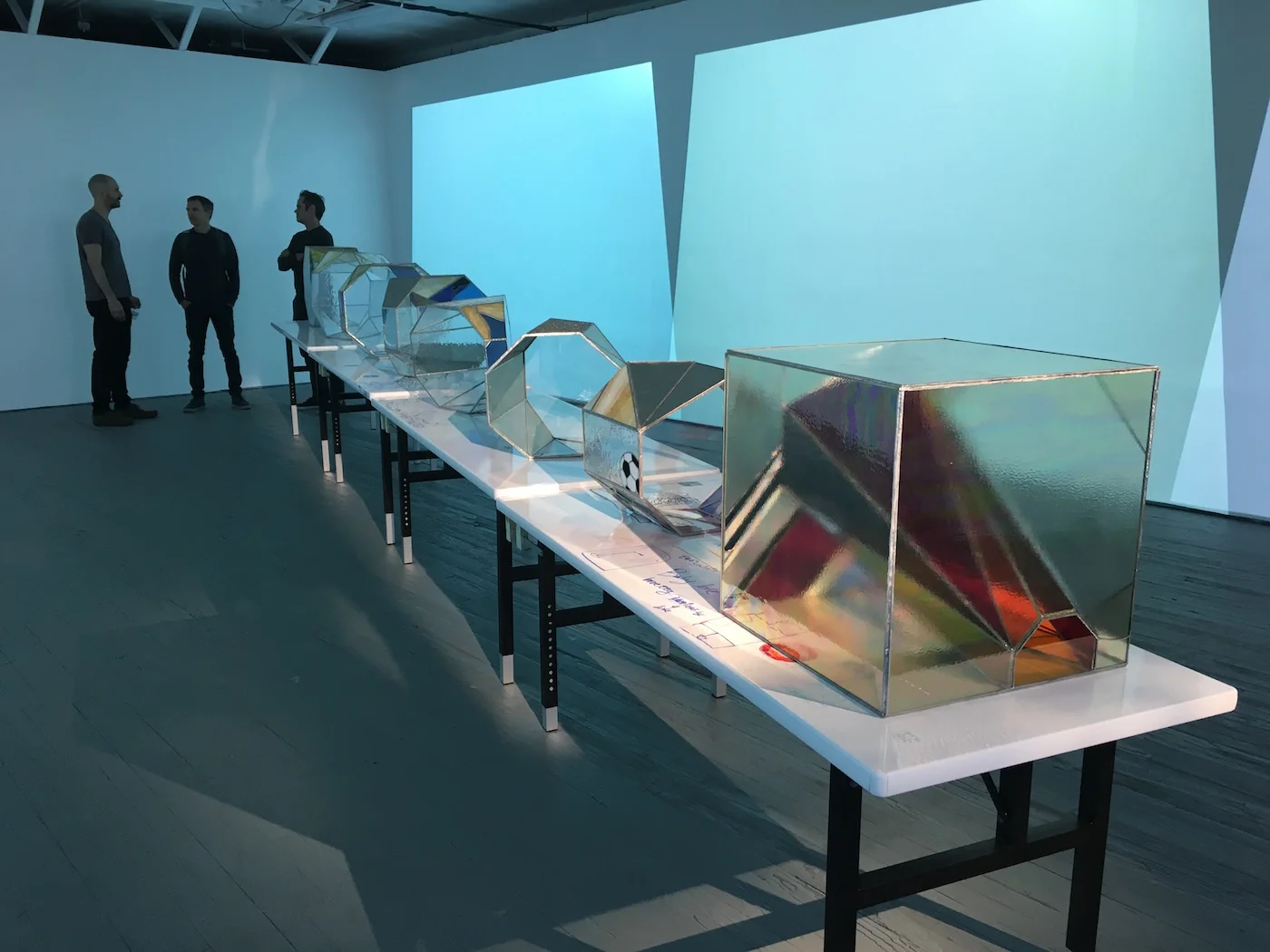 Christopher K. Ho, “Institution” (installation view) (2016), table with dry-erase drawings, colored glass, copper foil, palladium leaf, 24” x 30” x 34” (photo by the author for Hyperallergic)