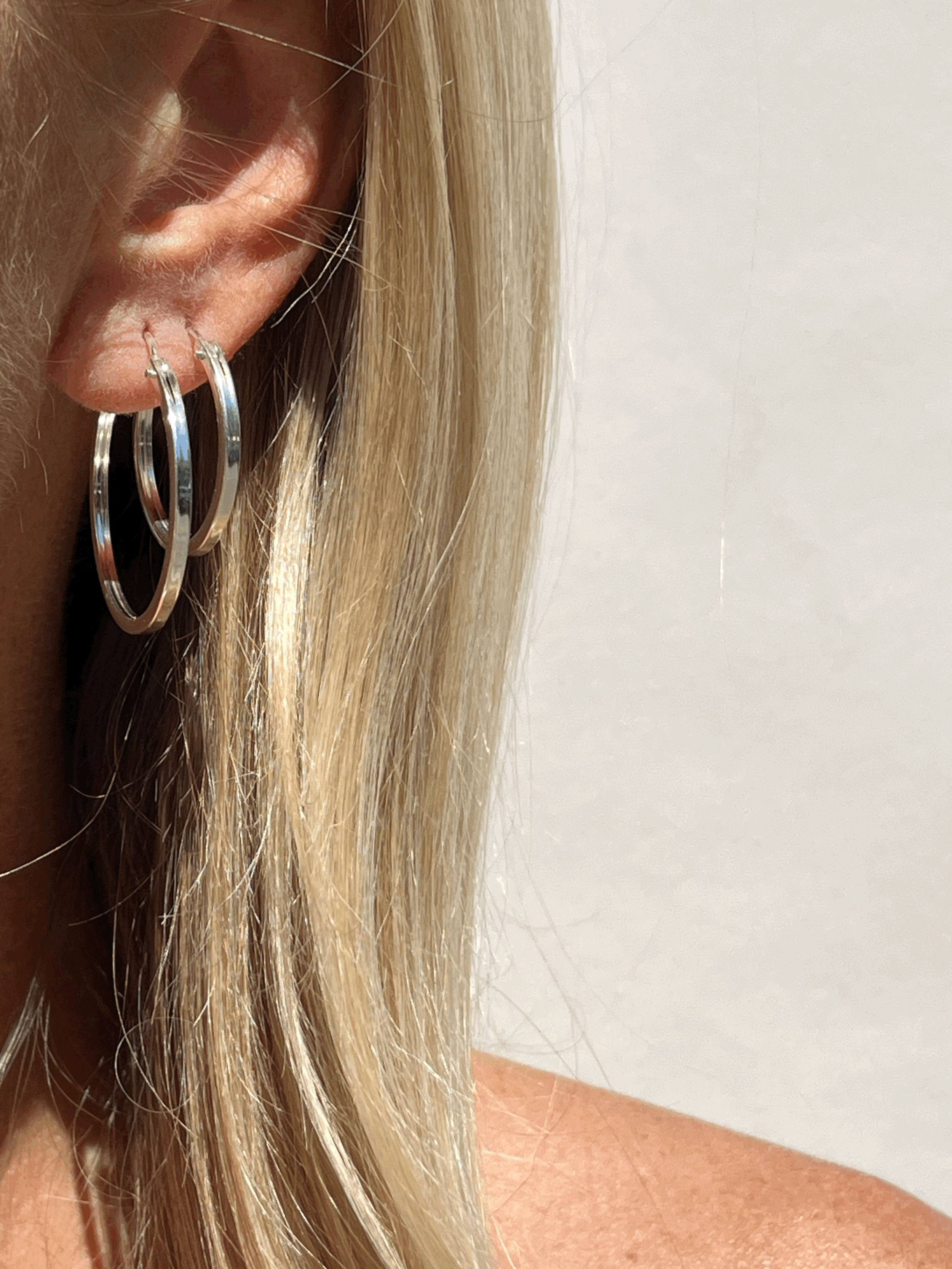 Woman wearing everyday silver click hoops | handmade minimalist jewelry | THALKEN