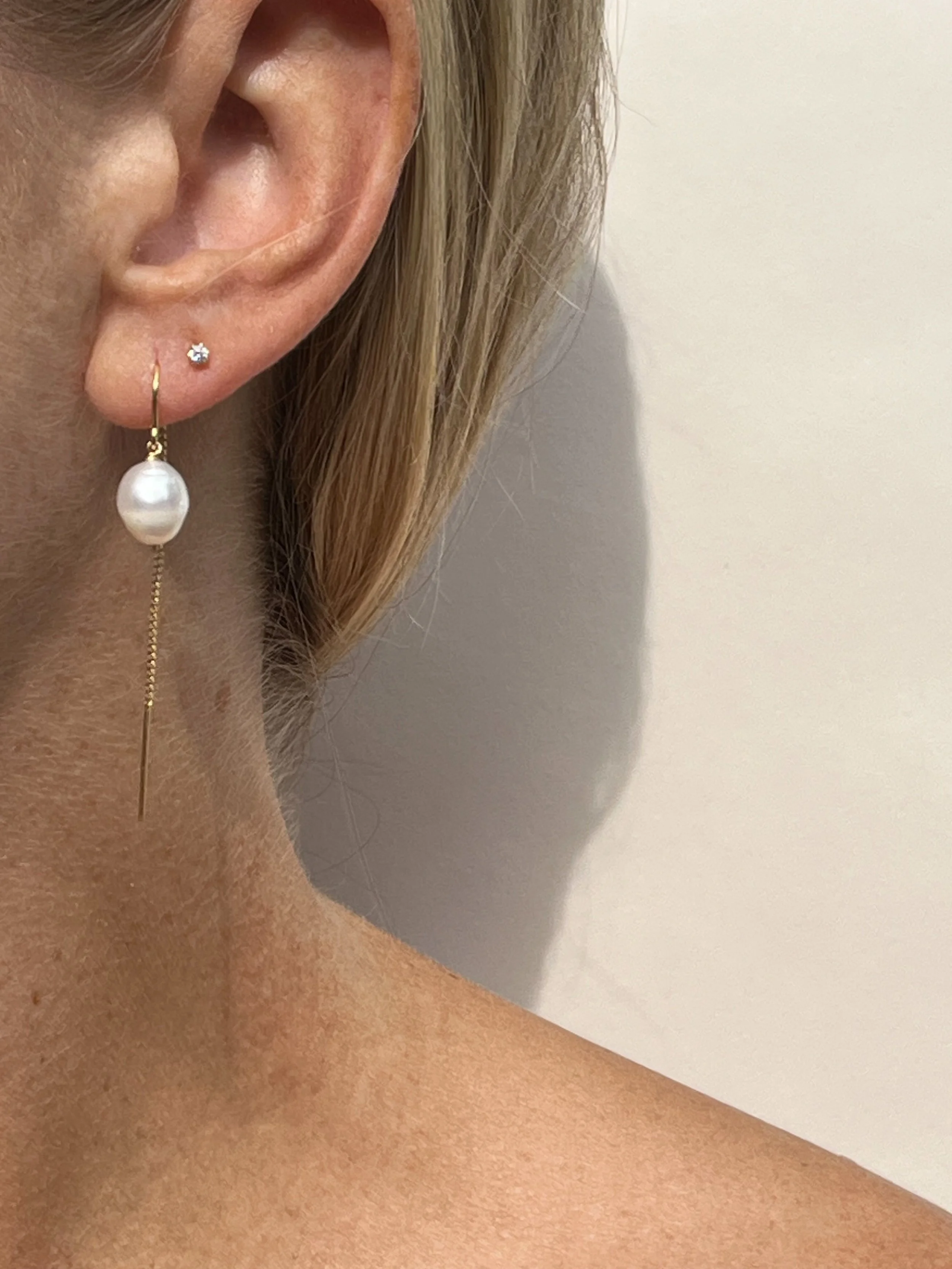 woman wearing freshwater pearl drop threader earrings in ear | handmade lafayette jewelry | THALKEN
