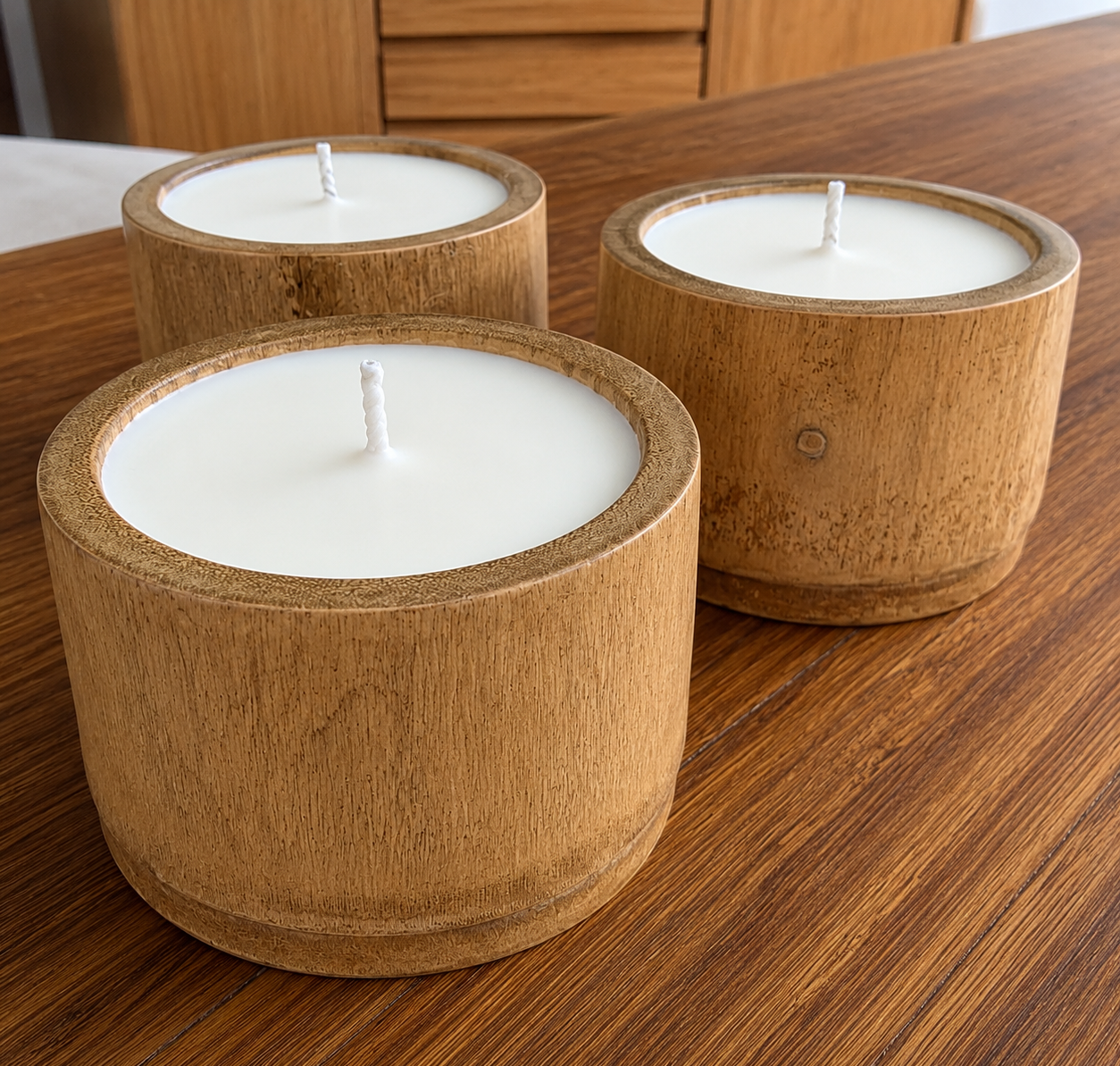 Three large GADWA handmade bamboo candles in natural Guadua containers — wholesale sustainable candles Colombia