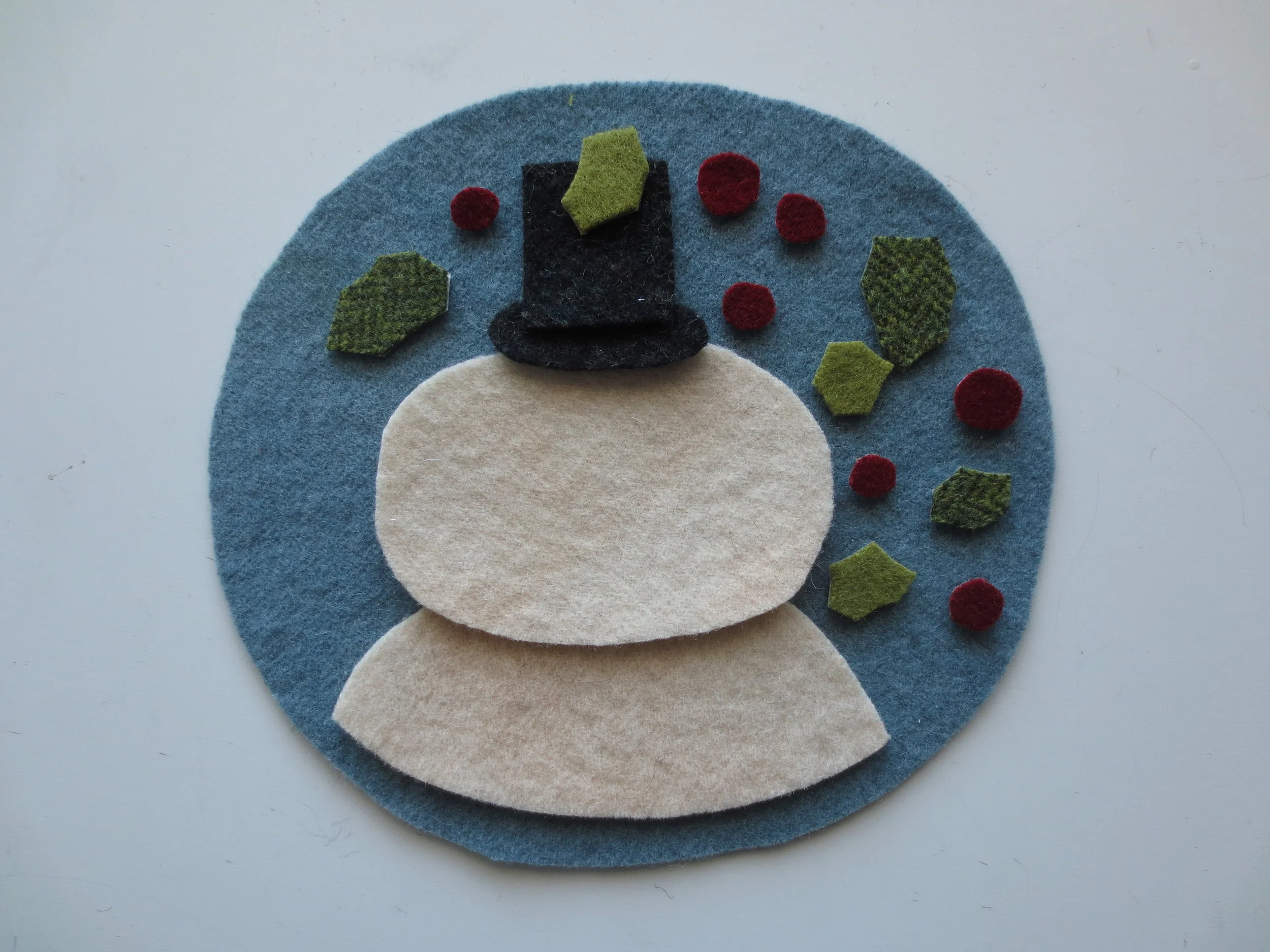Position all your wool pieces on the background.