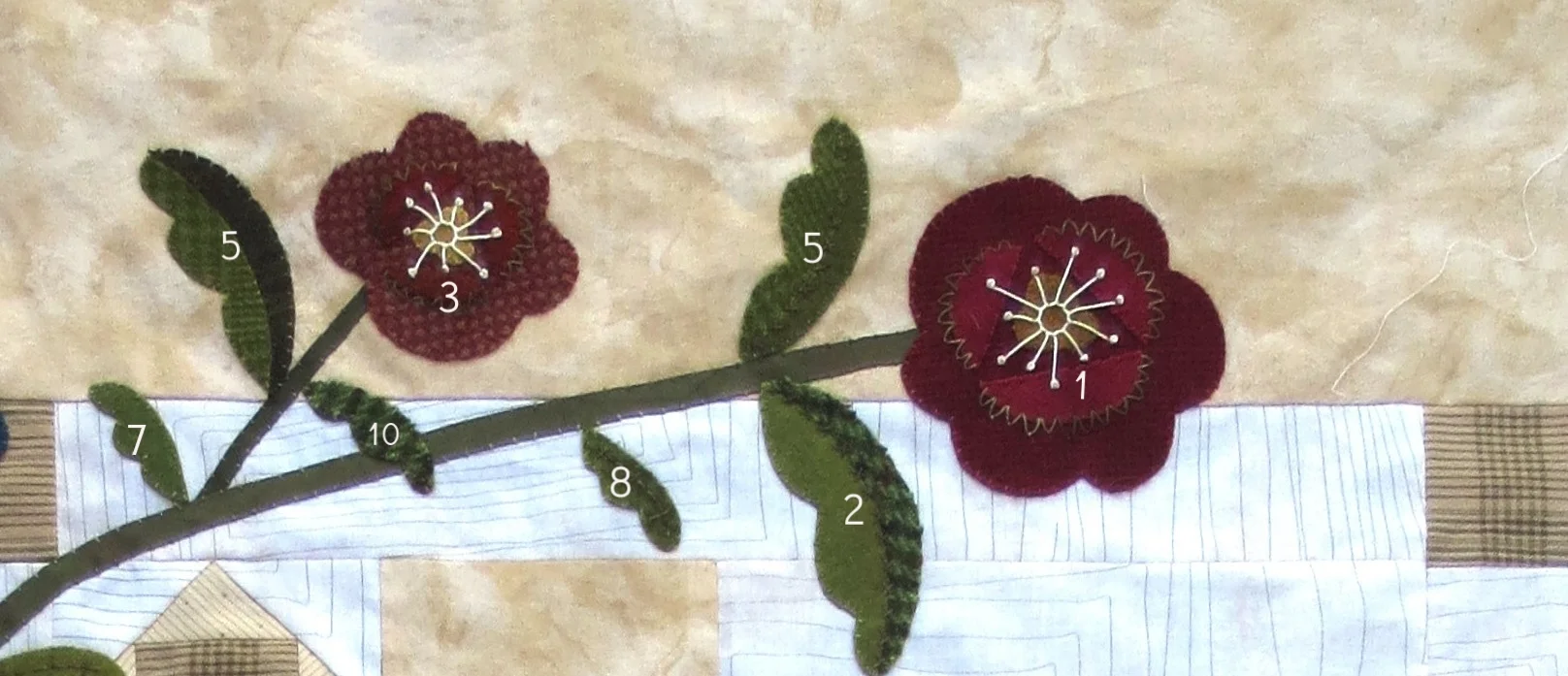 Flowers and leaves at top left side of quilt.