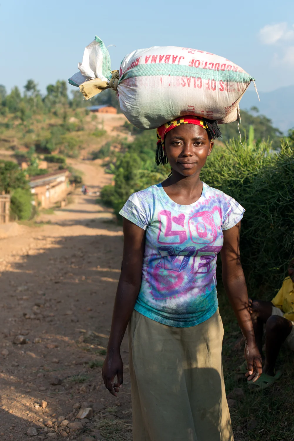  Woman carrying coffee on the road to Kigarama 