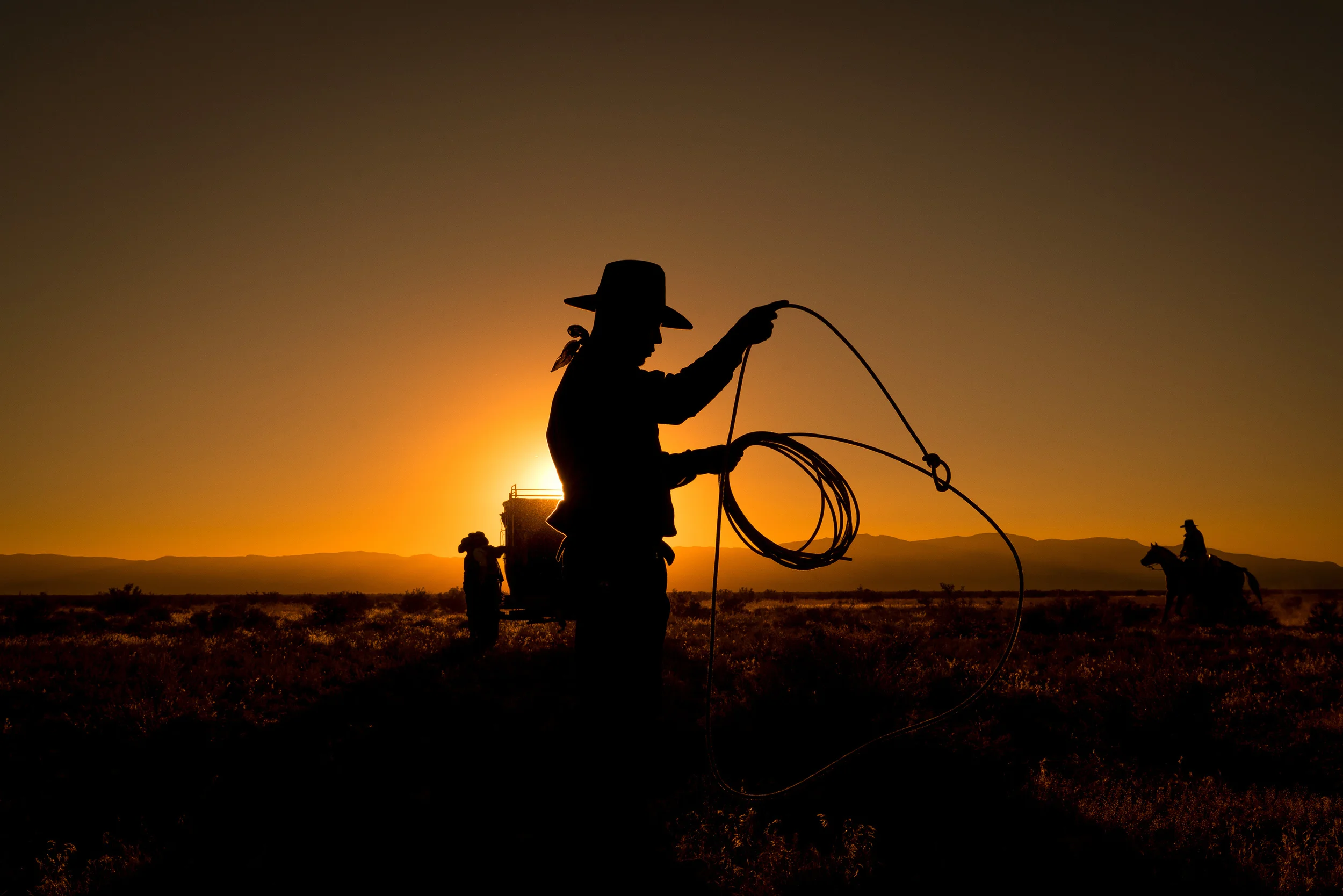 A cowboy works on his lasso skills at sunset in Skull Valley, Utah during the filming of The American West for AMC.