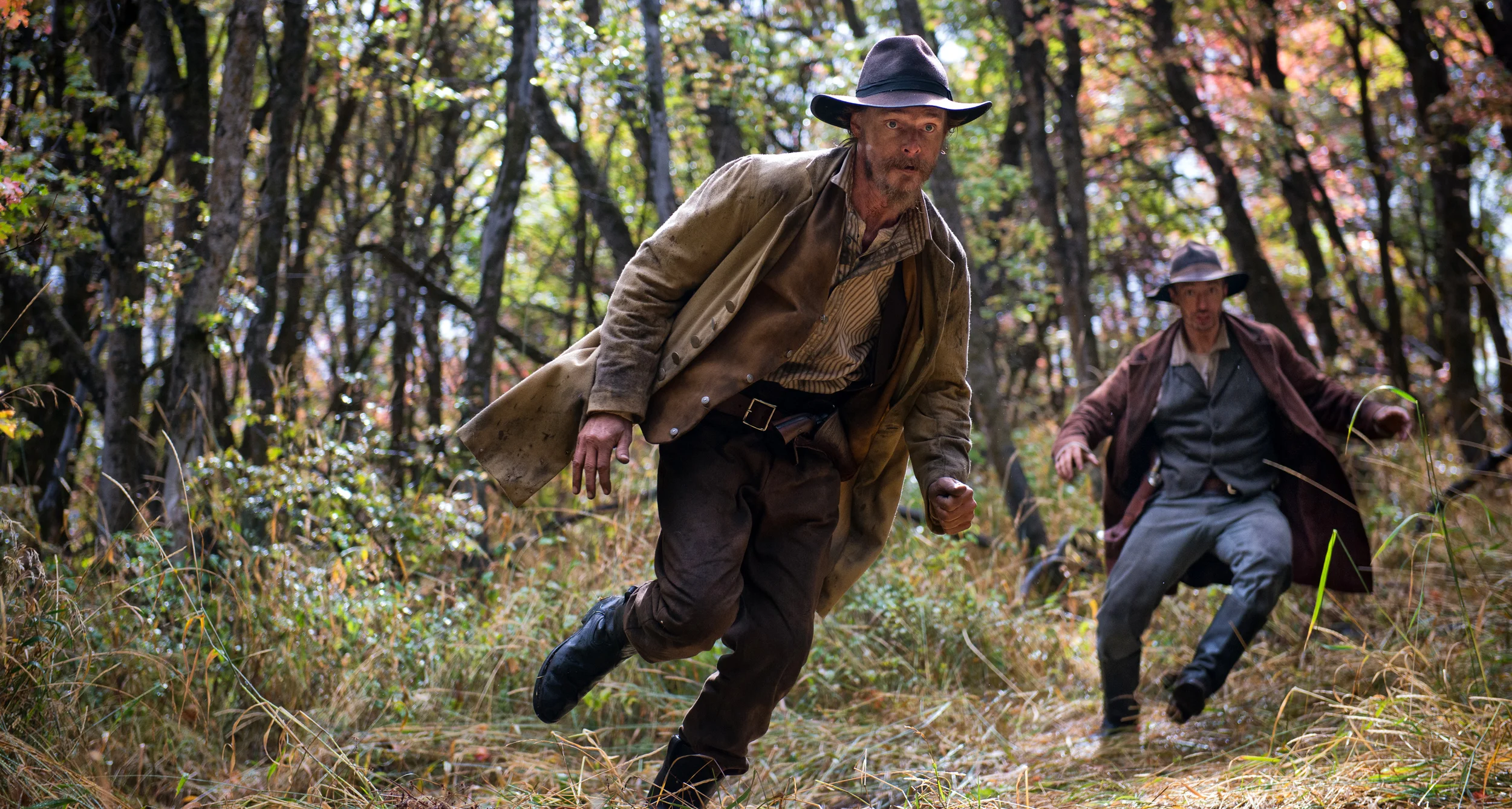 Jesse James played by David H. Stevens runs through the woods with Frank James trying to avoid a possee on the set of The American West near Midway, Utah.