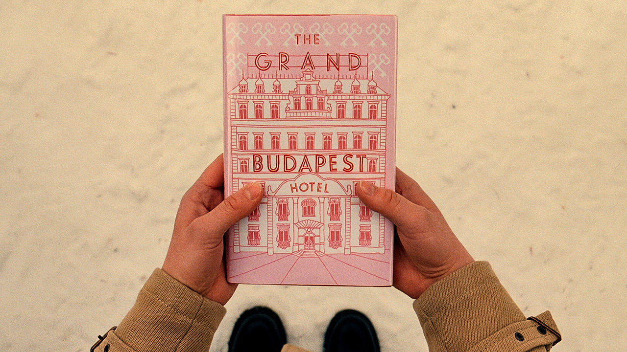 A scene from Wes Anderson’s “The Grand Budapest Hotel.” The lovely design of the book cover in this scene was an inspiration for the travel information card. Photo courtesy of Fox Searchlight.