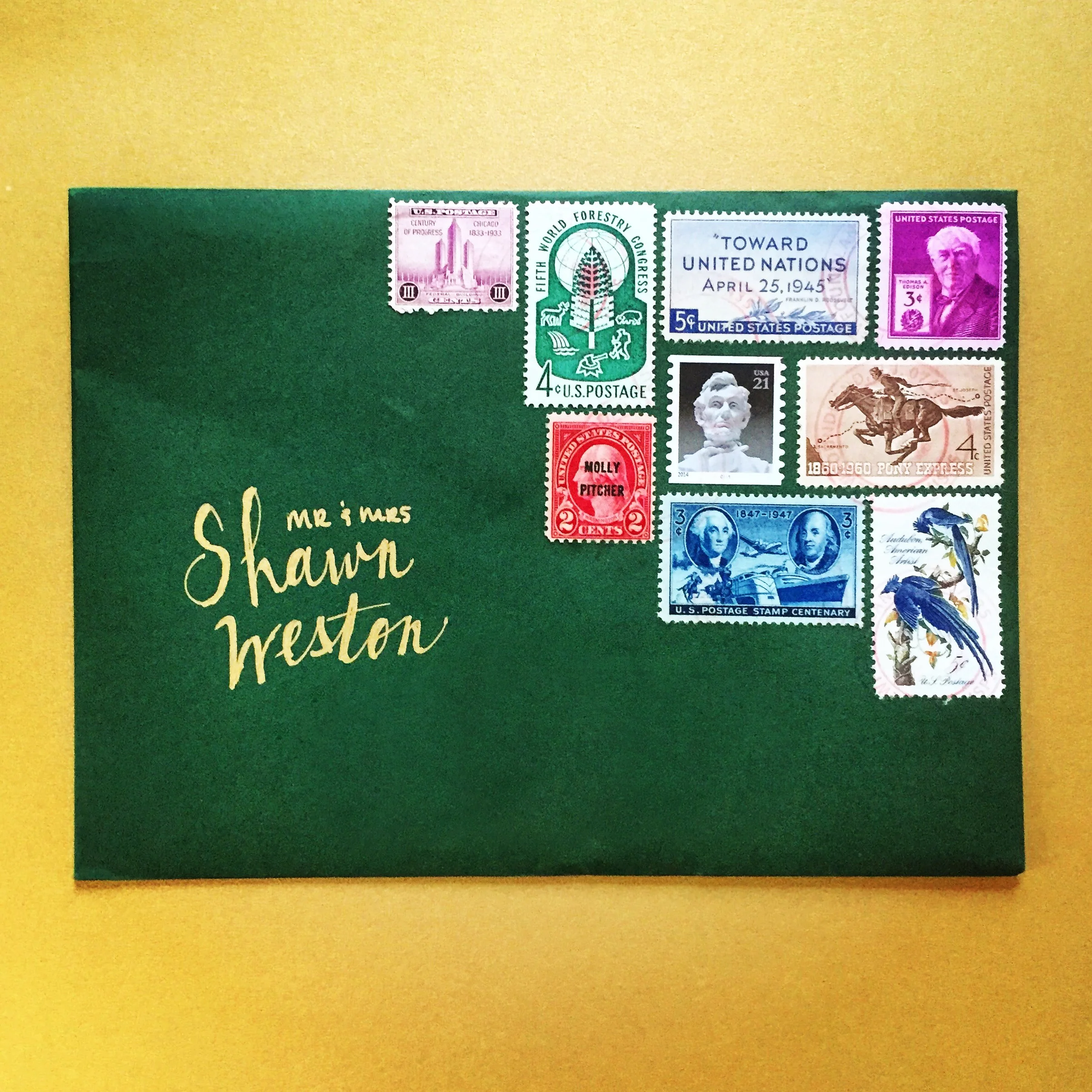 The envelope designed by Frances for the invitations includes an assortment of stamps.