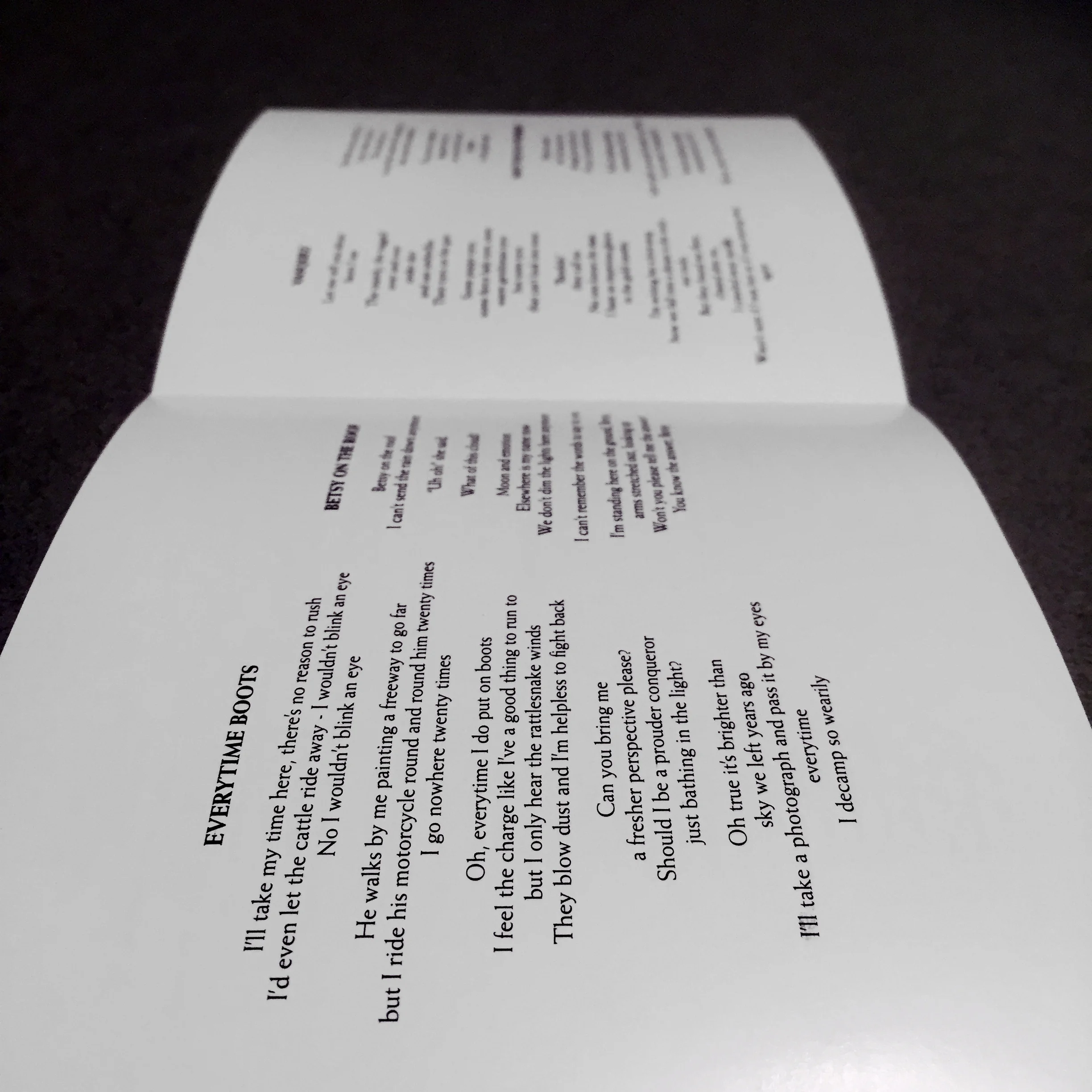 The inside flaps of one side of the liner notes, with song titles and lyrics.