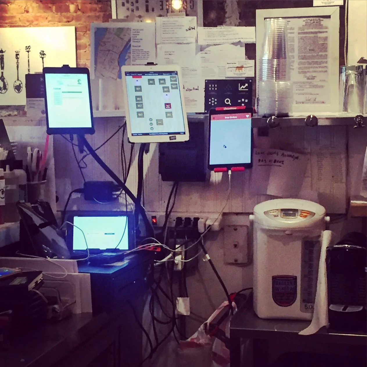 The multiple tablet screens behind the counter at Jack’s Sliders and Sushi help the hostess facilitate delivery orders from on-demand platforms.