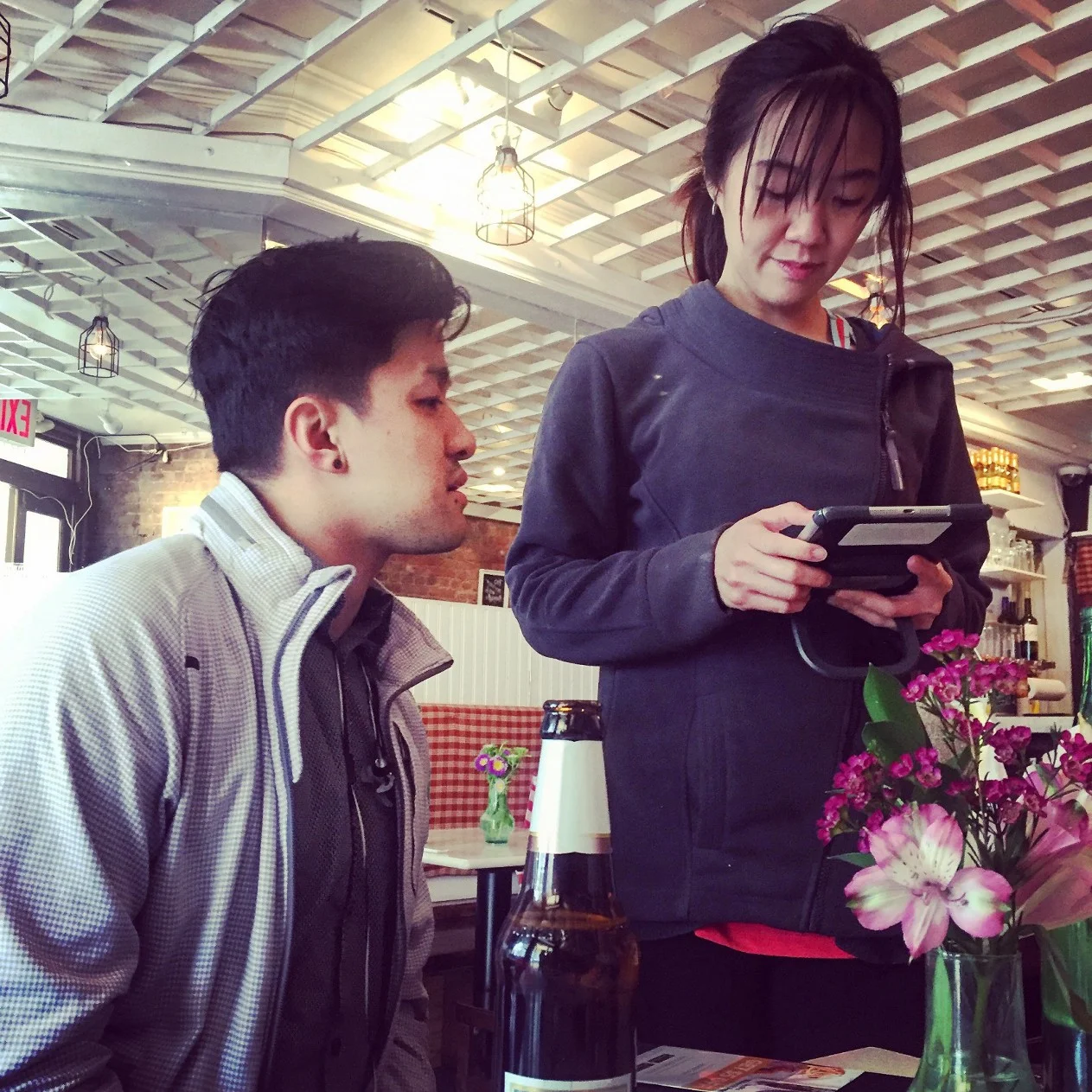 Using TouchBistro at our table, our hostess and server helps order our items.