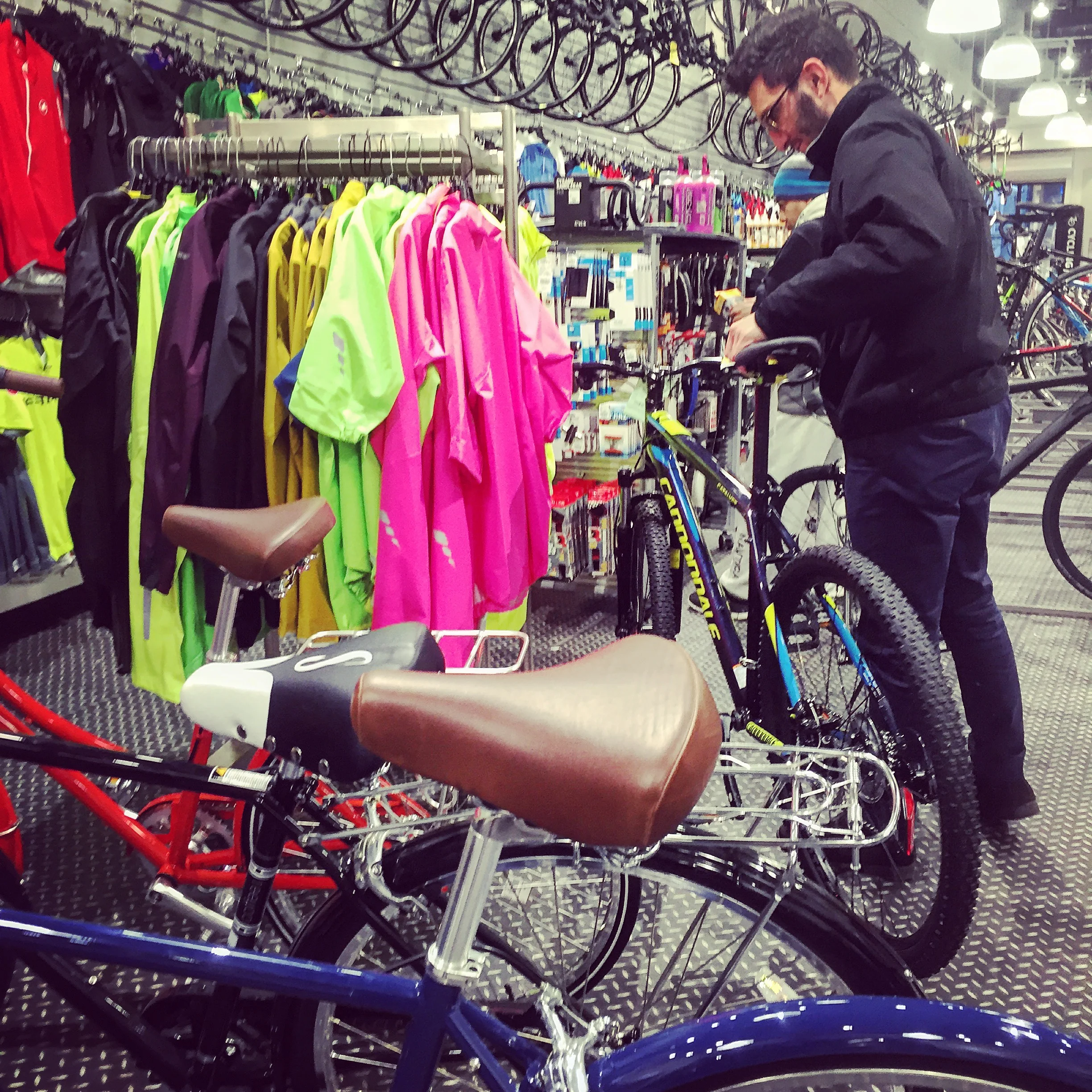 A customer inspects a bike. When it comes to sporting goods, users need to try out the products and be highly reassured they are the right products to purchase for them.