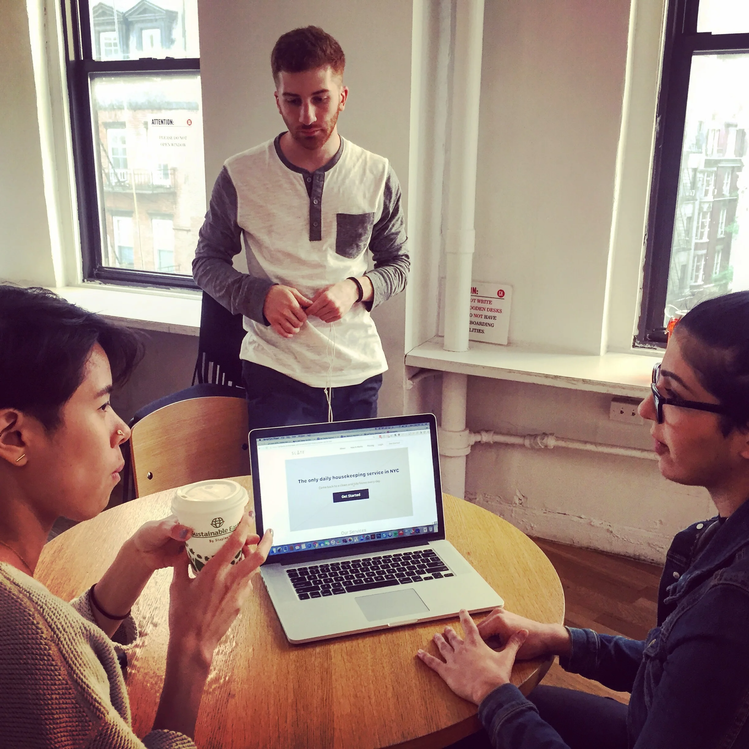 Mor (right) and Anthony (center) talk with a user after they work through some scenarios on the first iteration of our Slate site redesign.