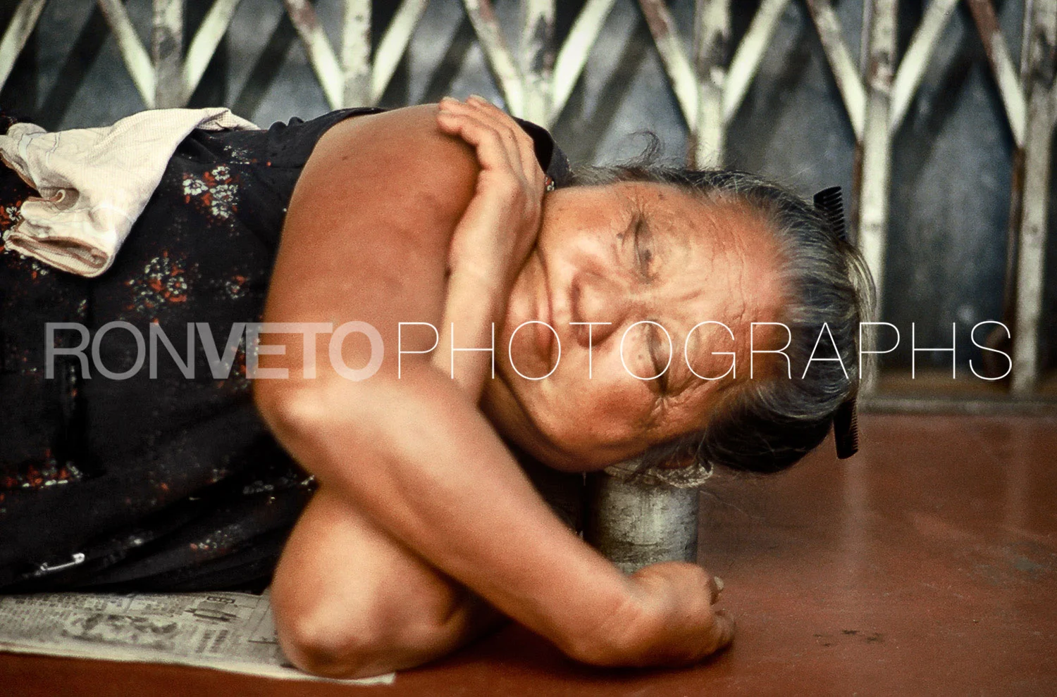 Woman sleeping on can, Thailand