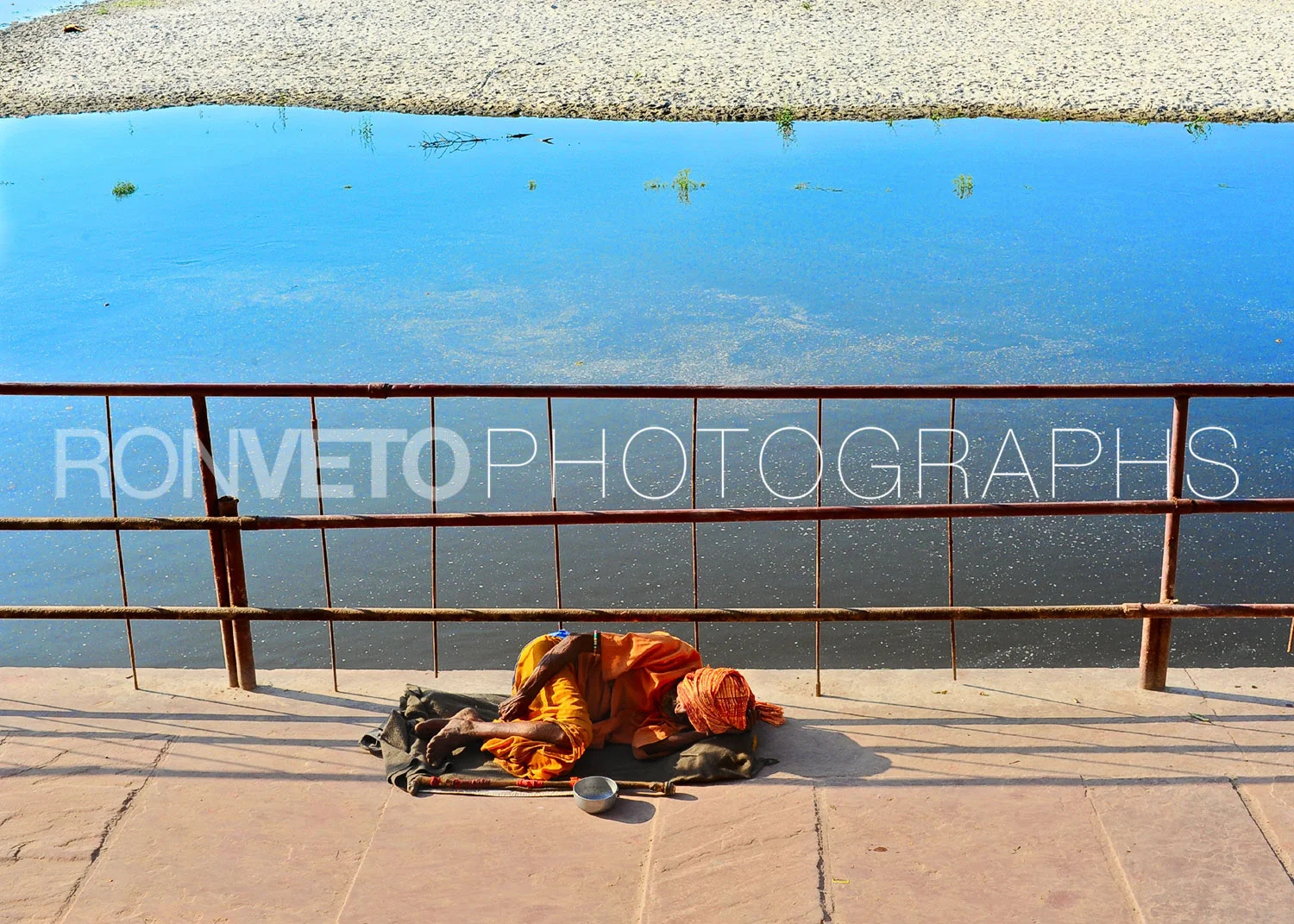 Guru sleeping on Holi river, Vrindavan, India