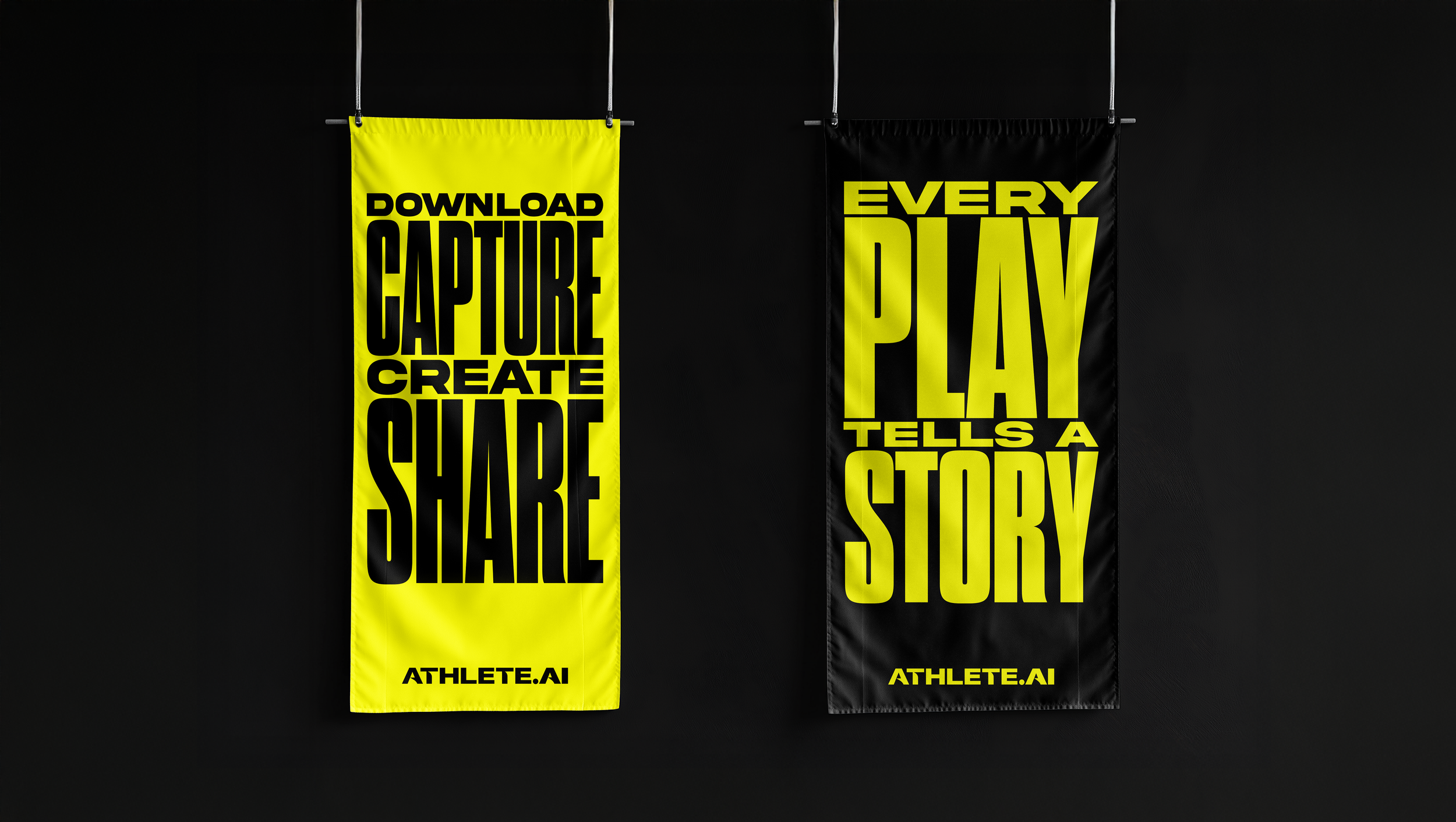 Two vertical banners on a dark wall, one yellow and one black, with motivational phrases in bold black and yellow text. The yellow banner says "Download Capture Create Share" with "ATHLETE.AI" at the bottom. The black banner says "Every Play Tells a Story" with "ATHLETE.AI" at the bottom.