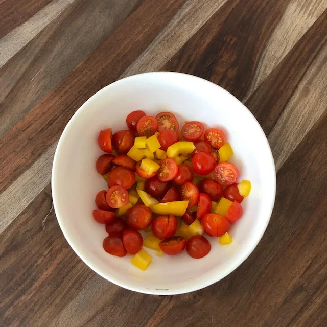 Step 1: Cut up your veggies of choice. I used baby tomatoes and bell peppers which are both high in vitamin C which is needed for a healthy immune system and helps your skin glow.