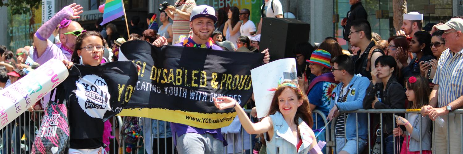 IMAGE: Image people cheering and holding banners from the Disability Pride Parade, 2014
