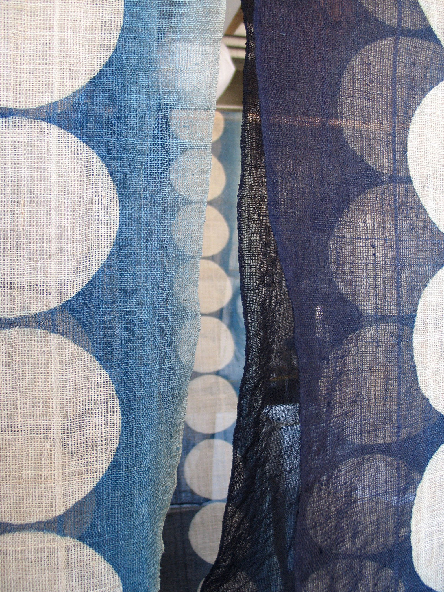 IMAGE - Artist Rowland Ricketts adjusts a hand-dyed indigo textile.