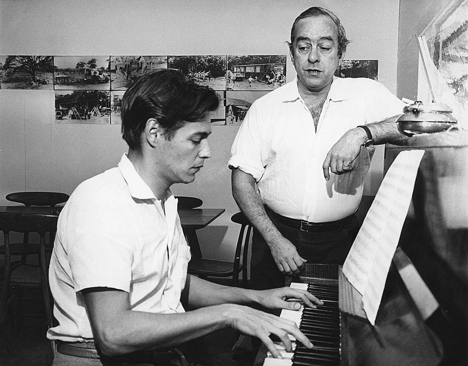Antonio Carlos ("Tom") Jobim (seated at the piano), and poet, lyricist, and singer Vinicius de Moraes (standing) were some of the earliest composers of what became bossa nova.