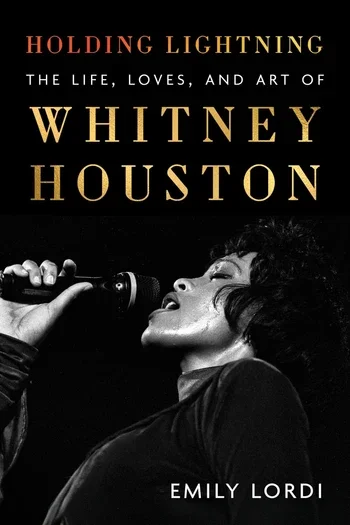 Vocalist Whitney Houston, a Black woman, holds a microphone in the foreground of a black background beneath the book's title.