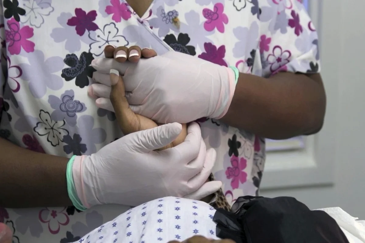 A nurse at Reproductive Health Services clinic in Montgomery, Ala. comforts a patient.