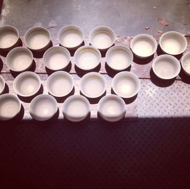 Freshly thrown bowls, drying in the sun.
