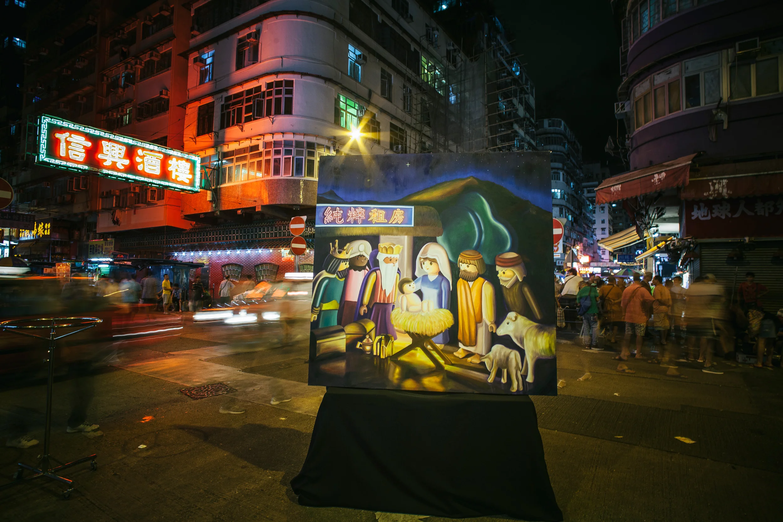 I brought the painting to Shum Shui Po in the middle of summer. The heat helps us to think outside the stereotypical feelings about Christmas.
