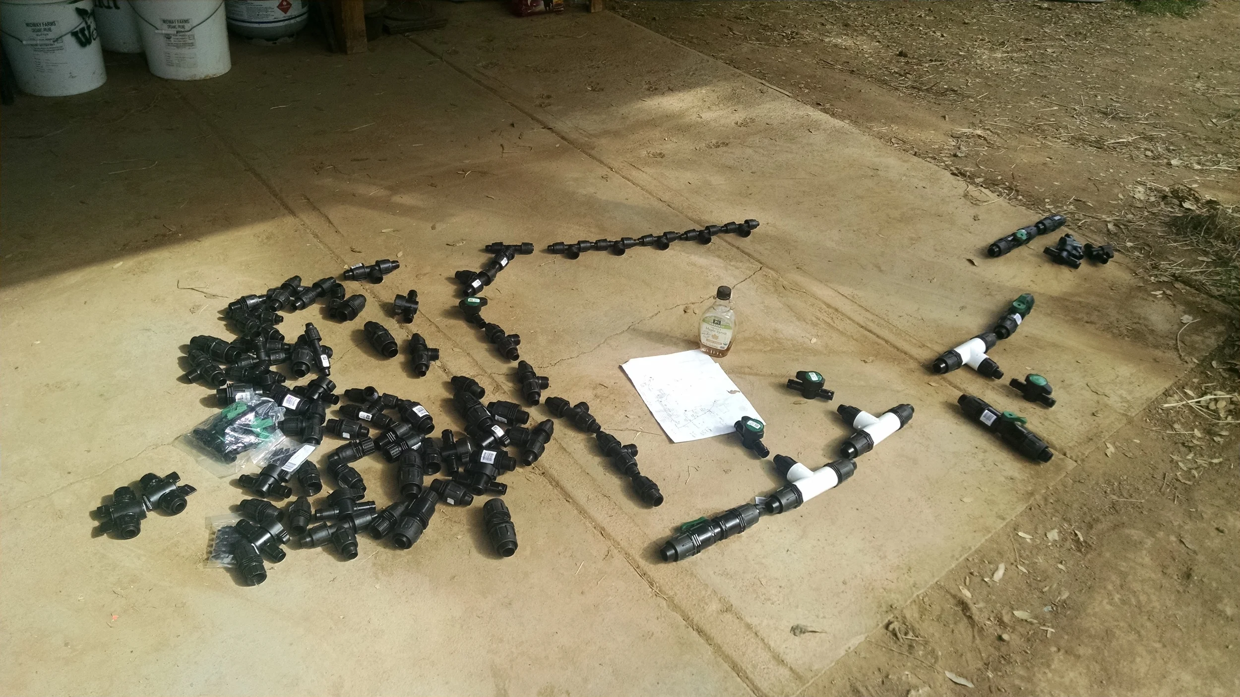  Laying out our gravity fed farm watering system.