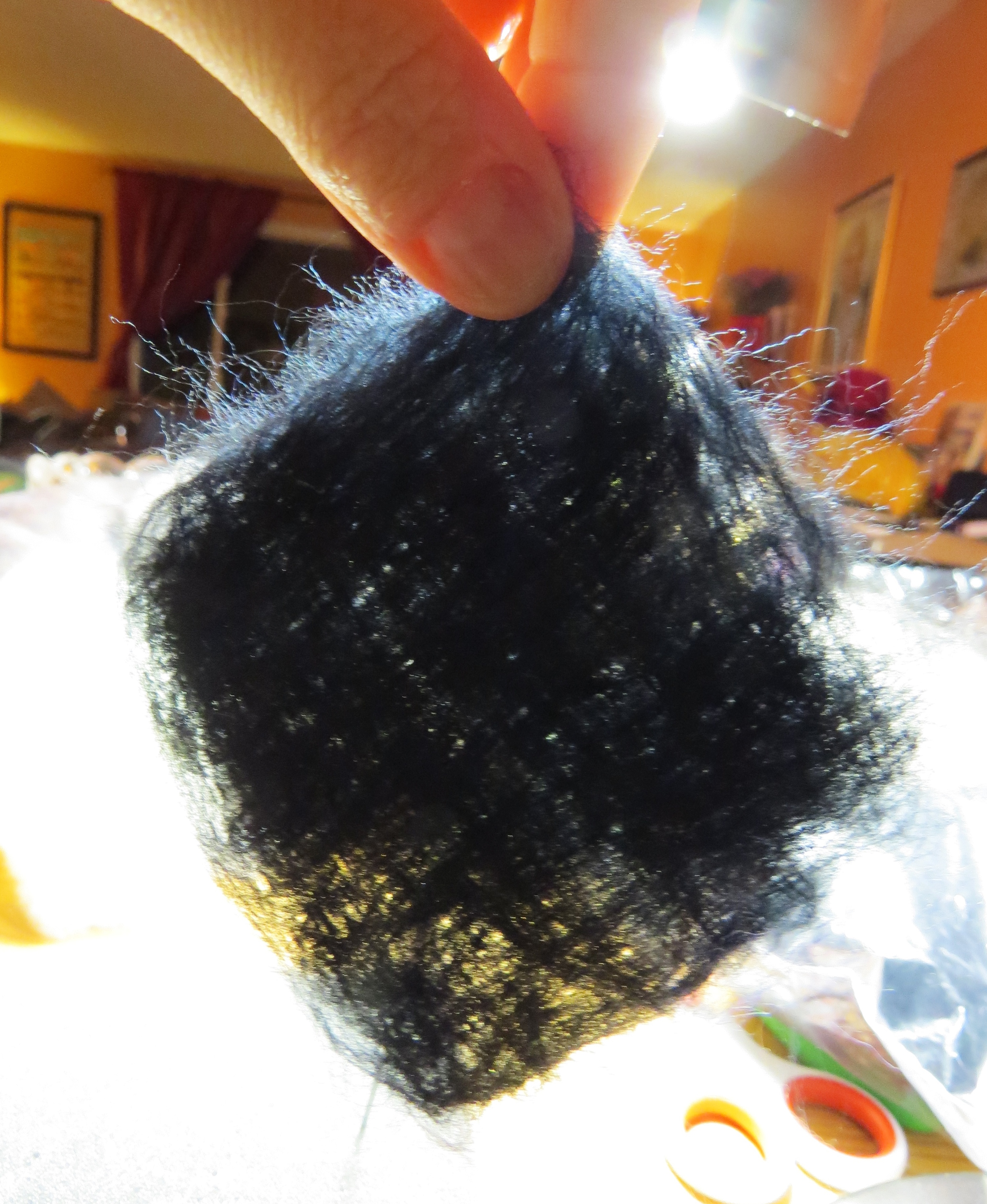 6. After flipping and adding layers a few times, hold the piece up to the light to see where it needs density. Holding this up, I could see from its woven appearance that I needed to add a few diagonal layers, so I did.