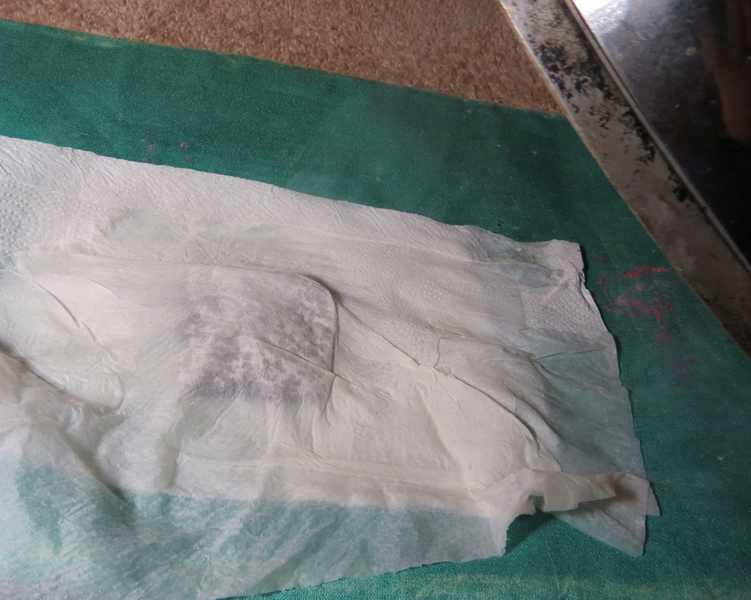 13. The iron is super hot! I like to use the paper towel as a barrier. You can see some steam coming up, here. Iron until the steam stops.