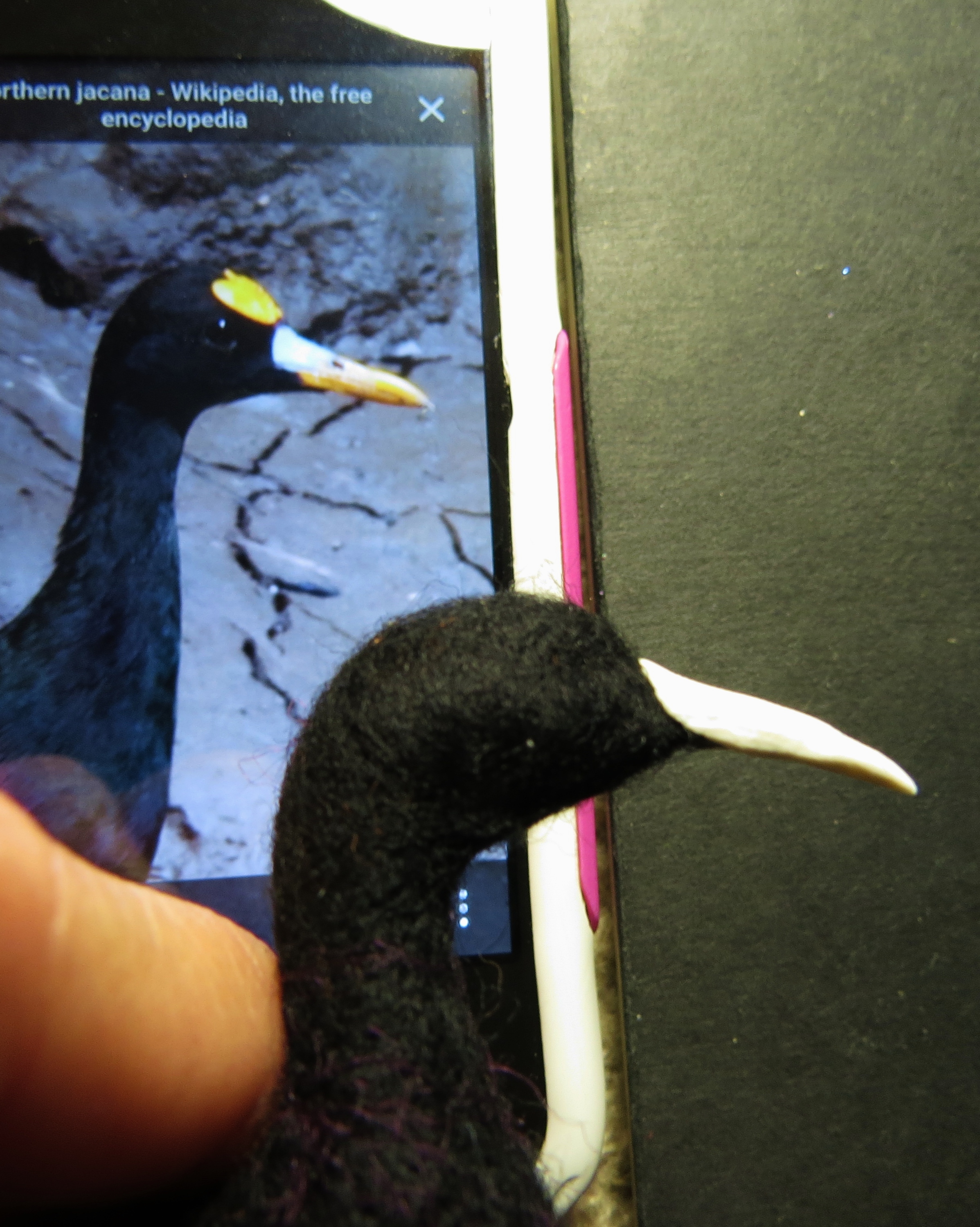 11. Place a wad of Sculpey onto the wire, and surround the wire completely. Make sure the wire is not close to the surface anywhere. Push the base gently into the wool so that the Sculpey grips it a bit.