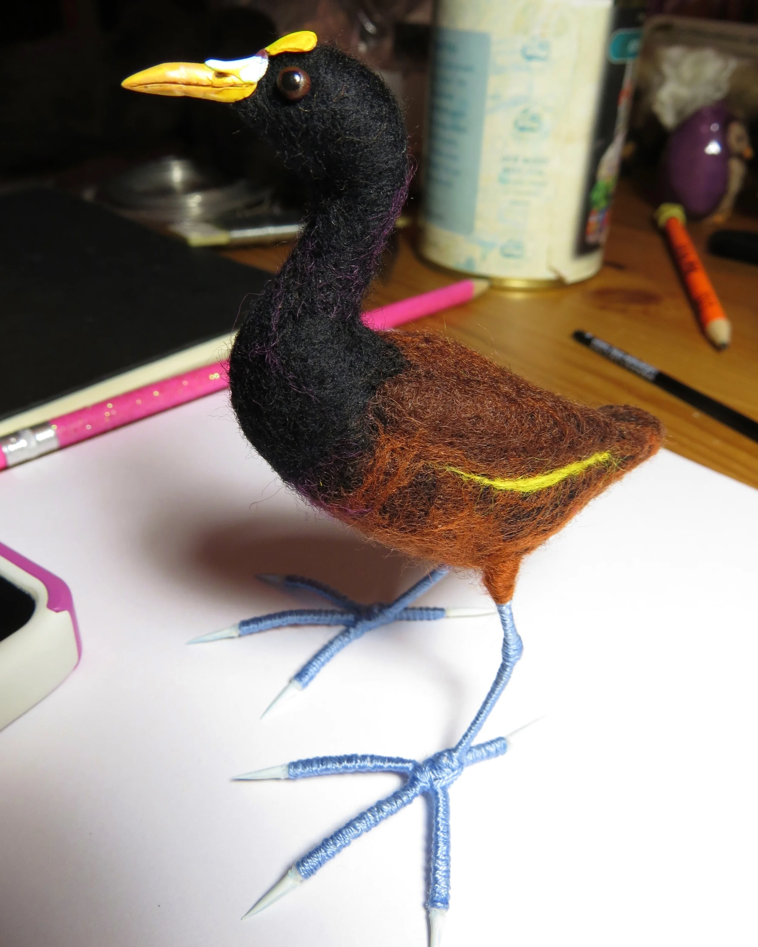 23. The rest is all painting and gluing. I like acrylic paints. Find images of your bird on Wiki and match the colors as best you can. The toenails are pale blue; so is the cere. The eyes are dark brown. Look at photos of the bird as you place the eyes; putting them in the wrong place can give your bird a weird expression.