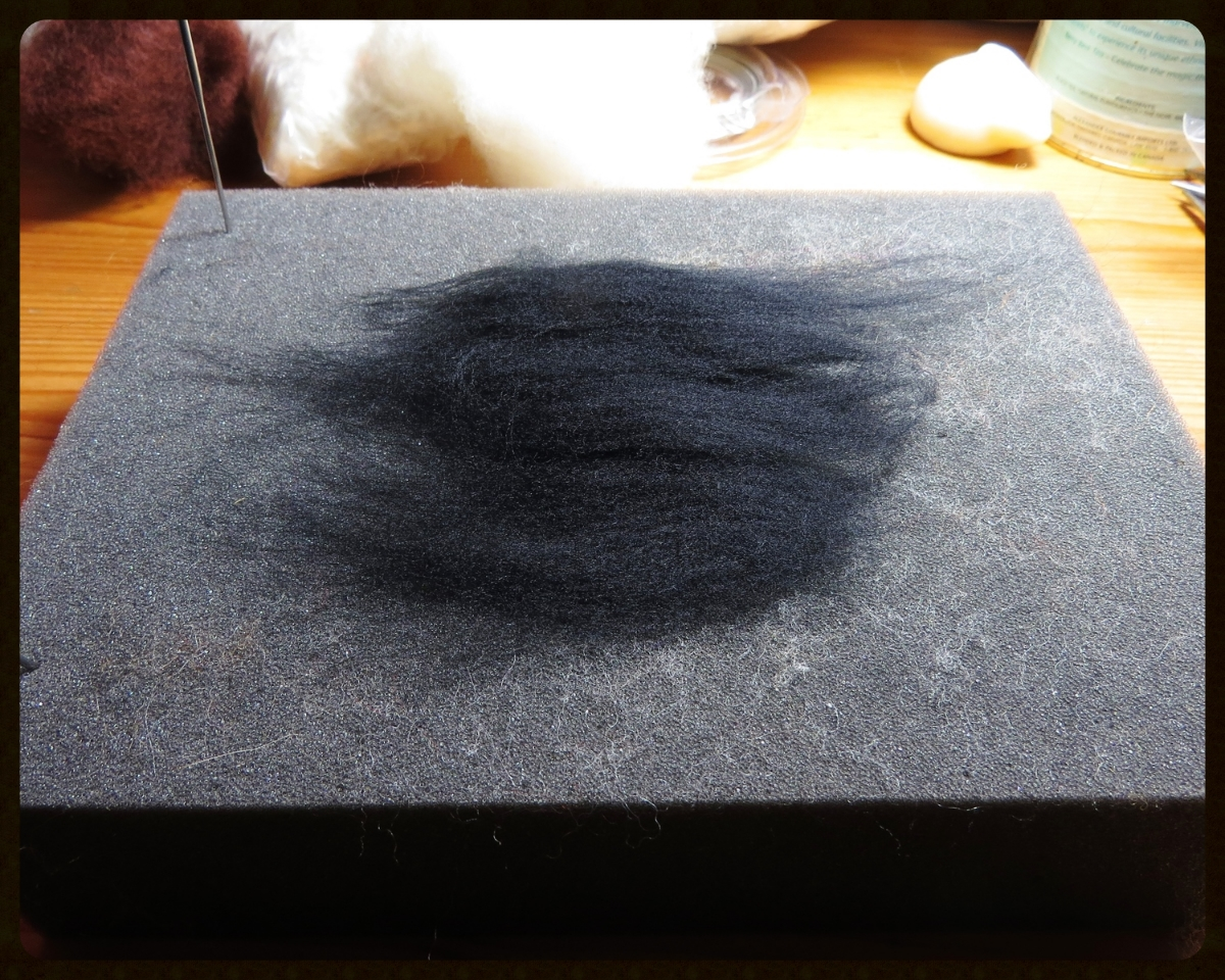 1. Lay out a very thin layer of wool with the fibers all going the same direction. Make sure there are no obvious gaps in the fibers. (Look, there's one of Sarafina Fiber Art 's lanolin bunnies! I'm going to need it for my hands after I use so much dish soap.)