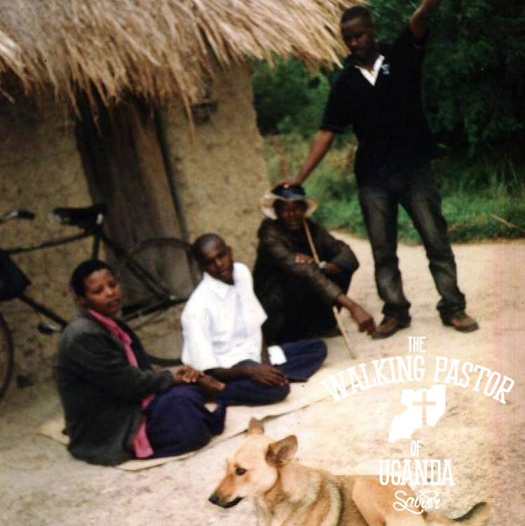 Kusasira praying over people at a village in Uganda